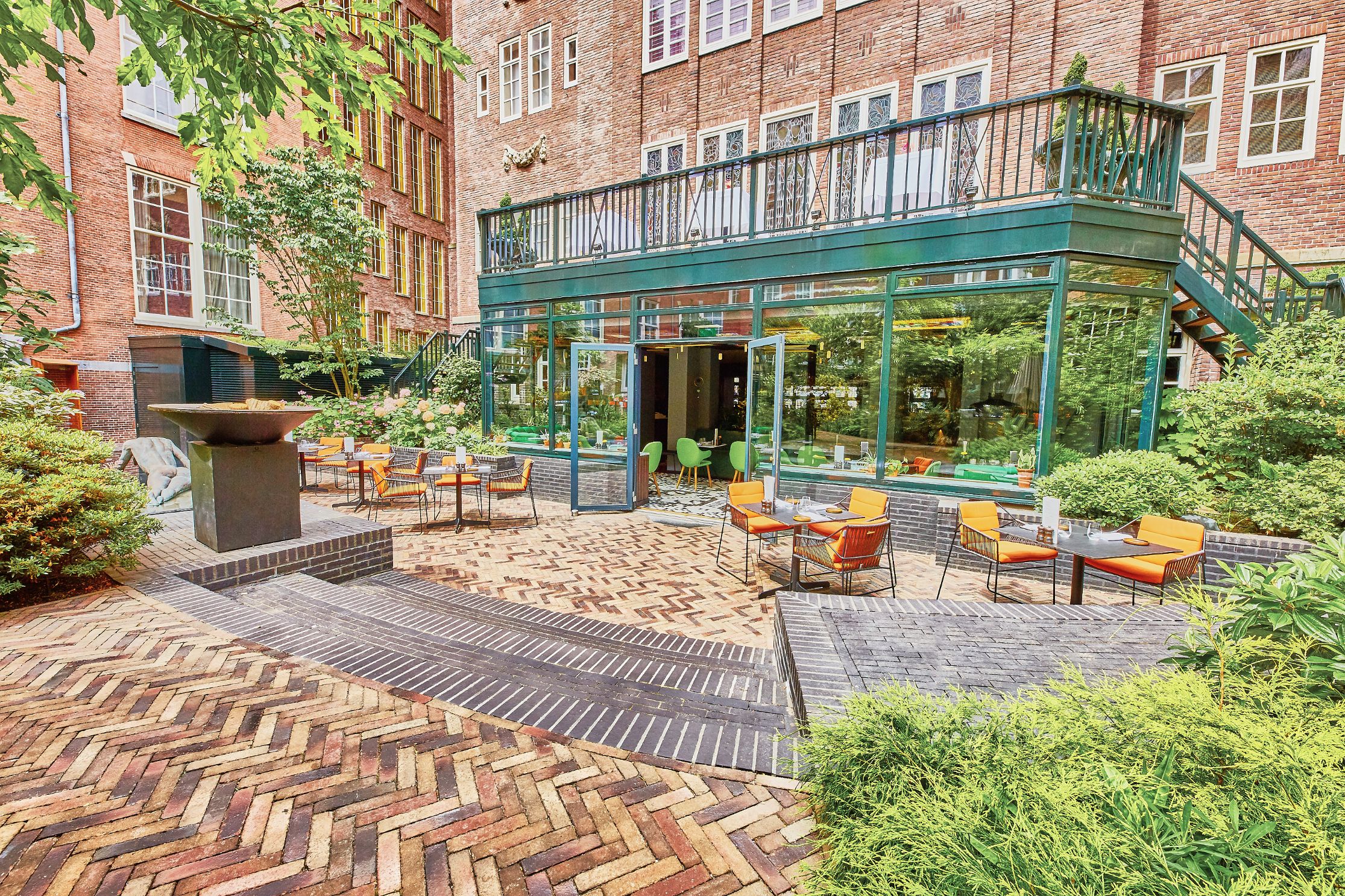 a patio with tables and chairs in front of a building