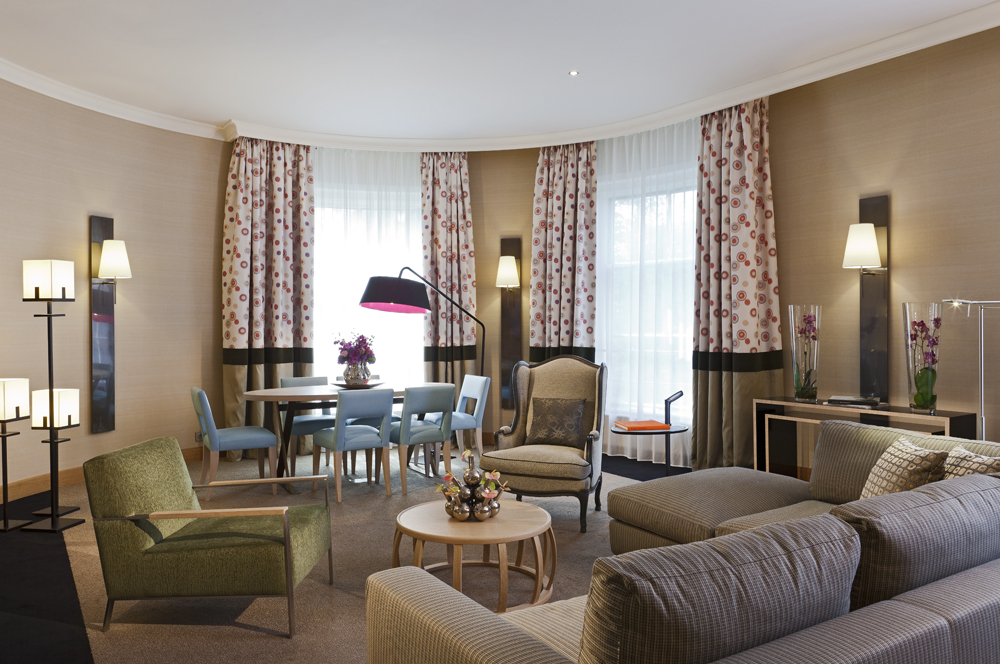 a living room with a round table and chairs