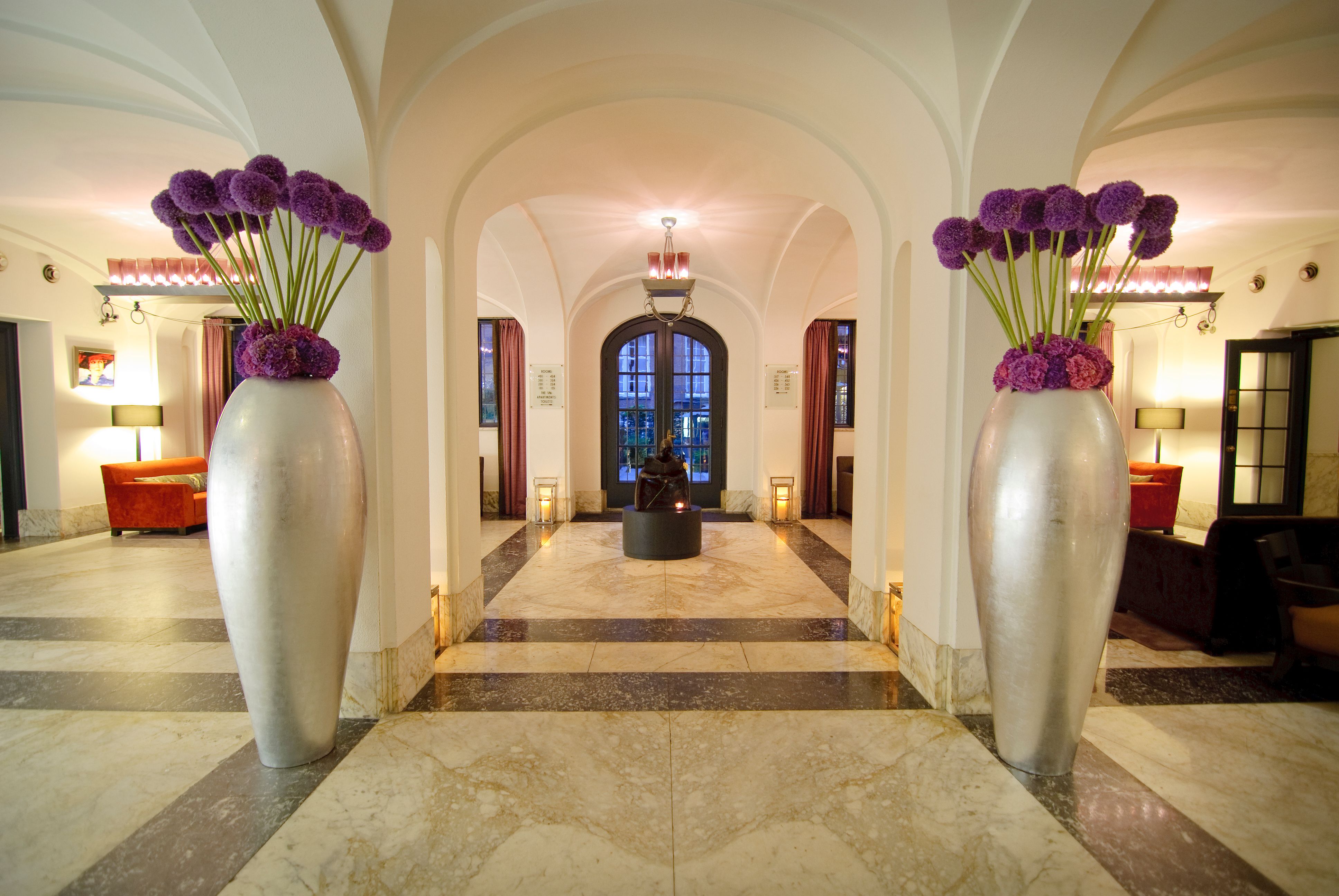 a large vases of purple flowers in a hallway