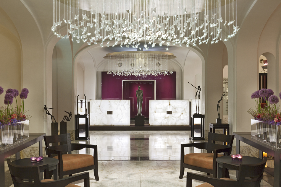 a room with a statue and a chandelier