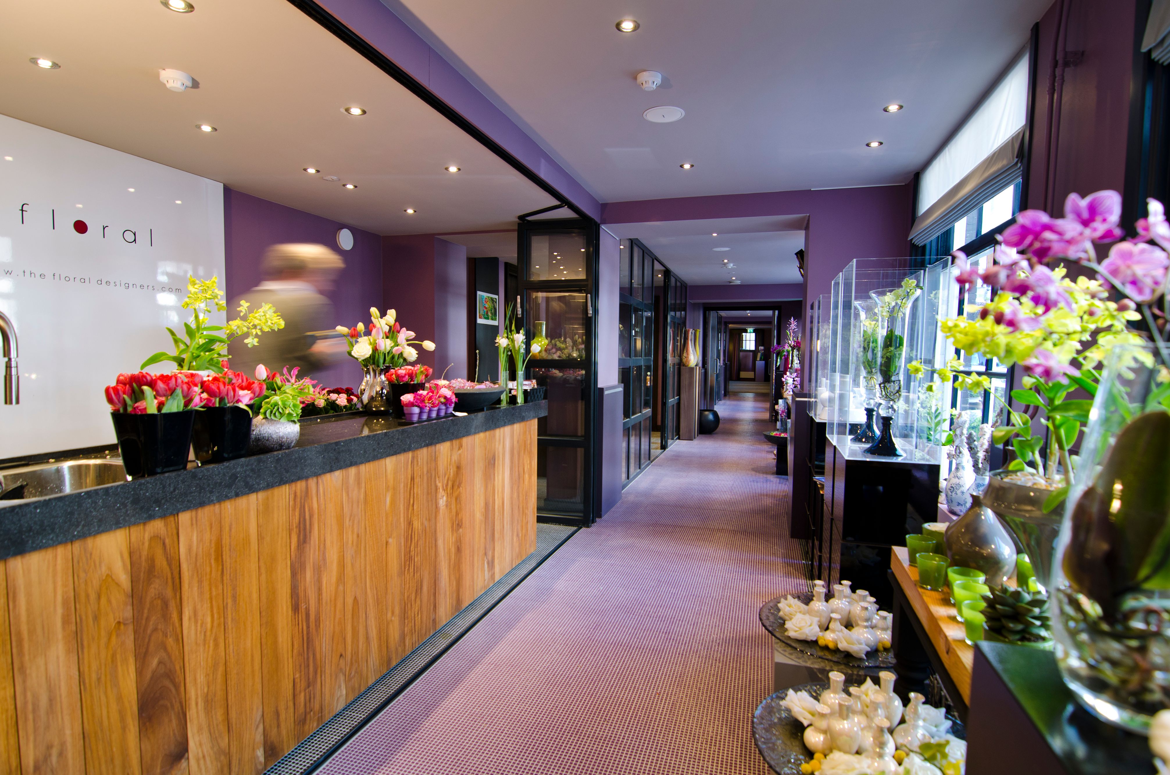 a hallway with a counter and flowers