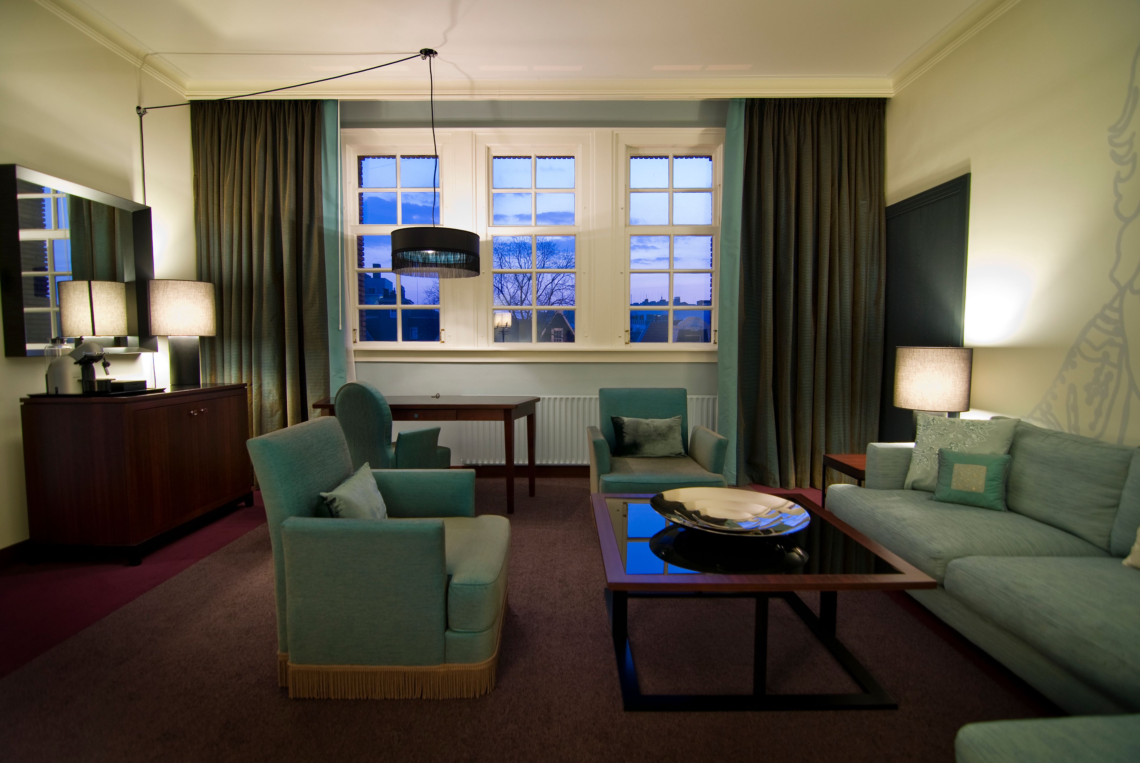 a room with a couch and chairs