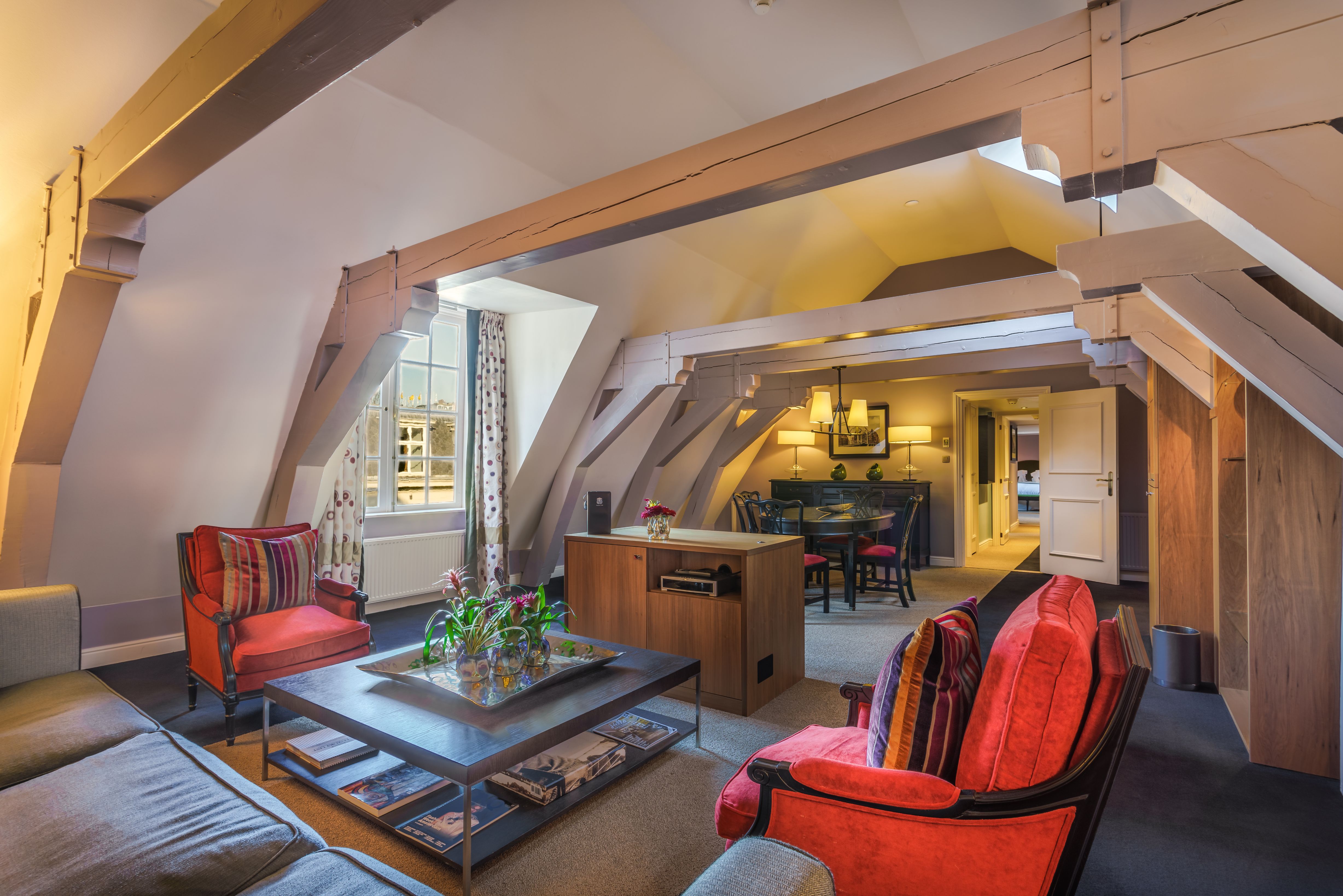a living room with a table and chairs