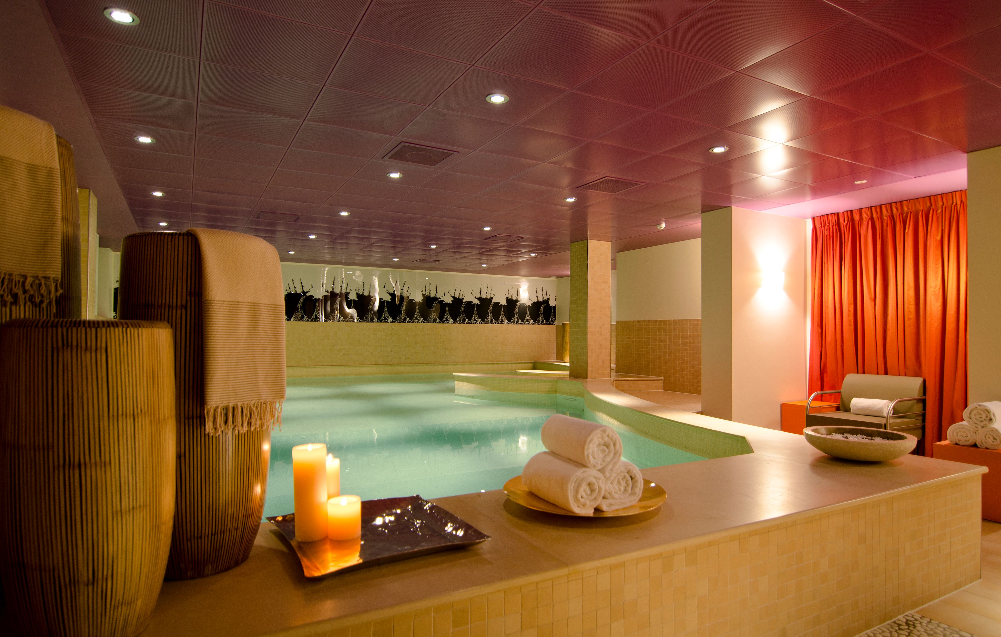 a pool with candles and towels