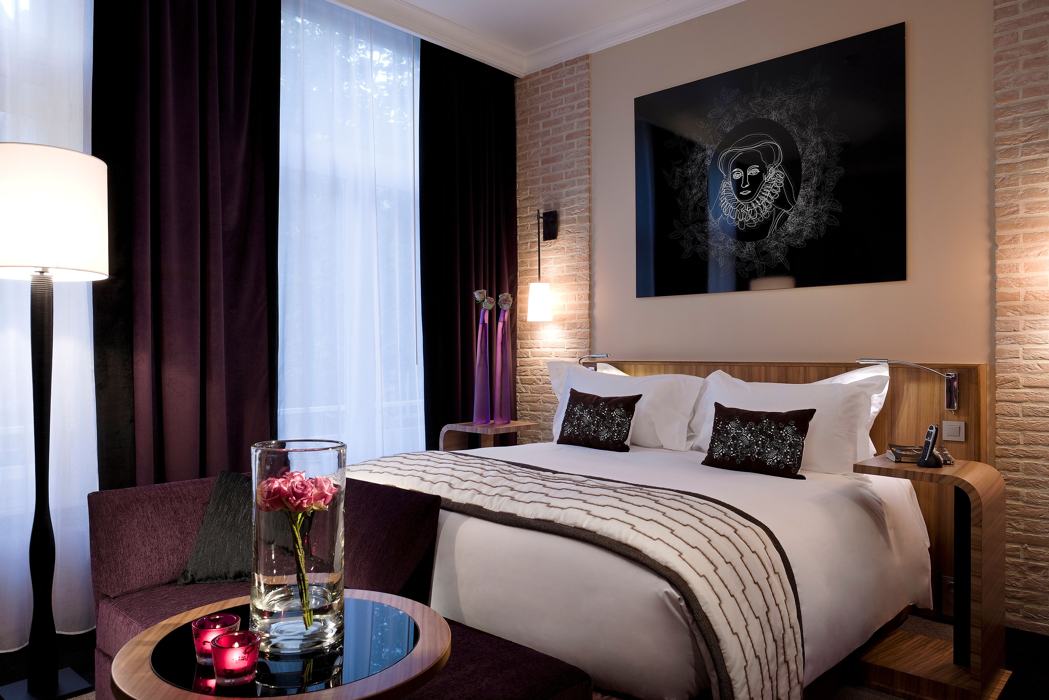 a room with a bed and a table with flowers
