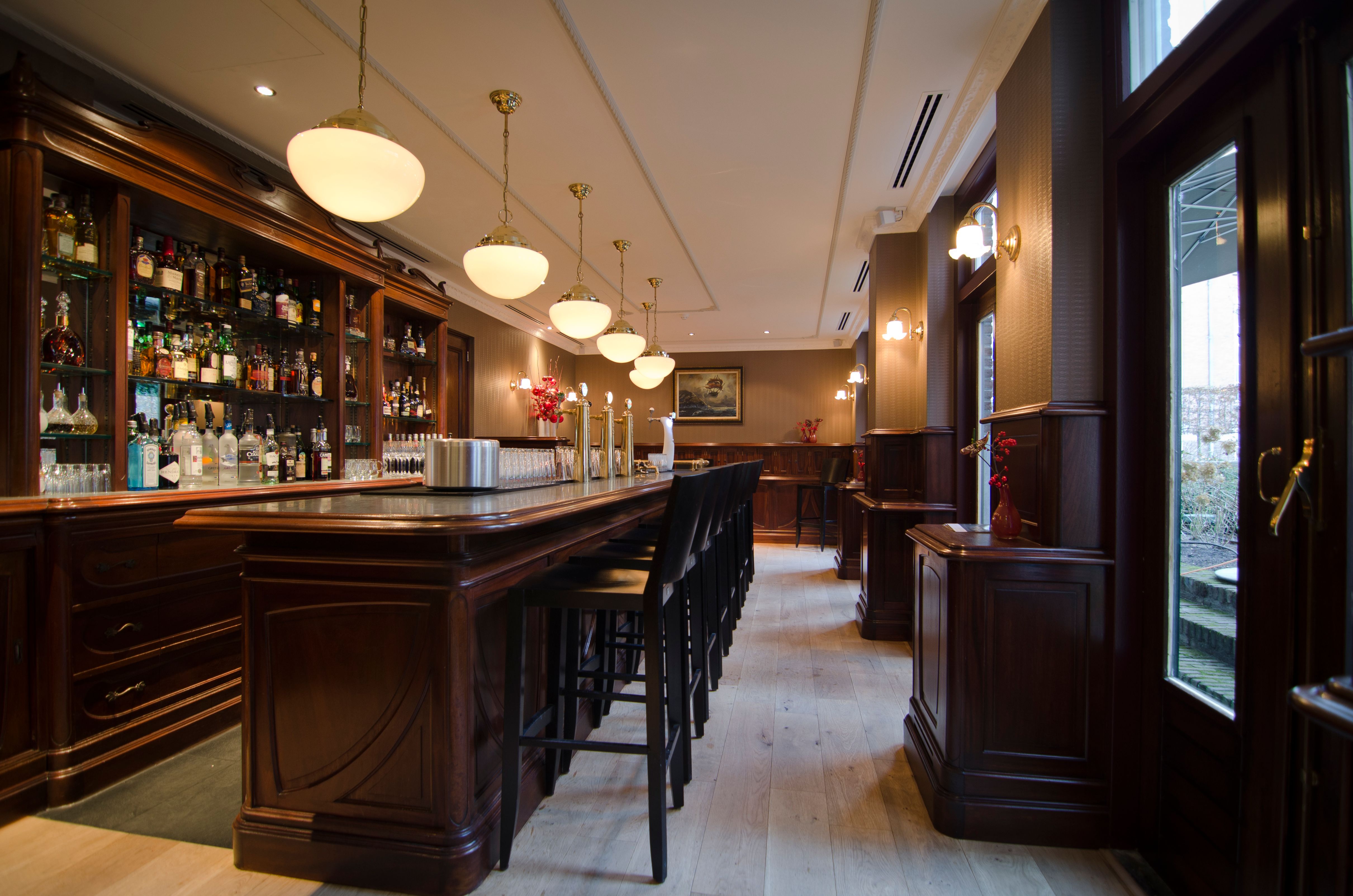 a bar with chairs and lights