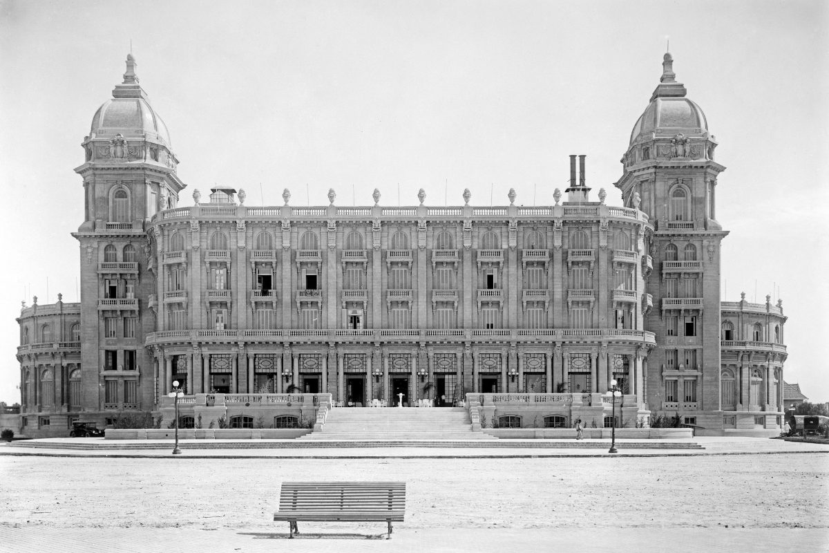 a large building with a bench in front of it