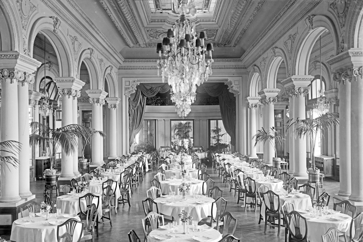 a long room with tables and chairs