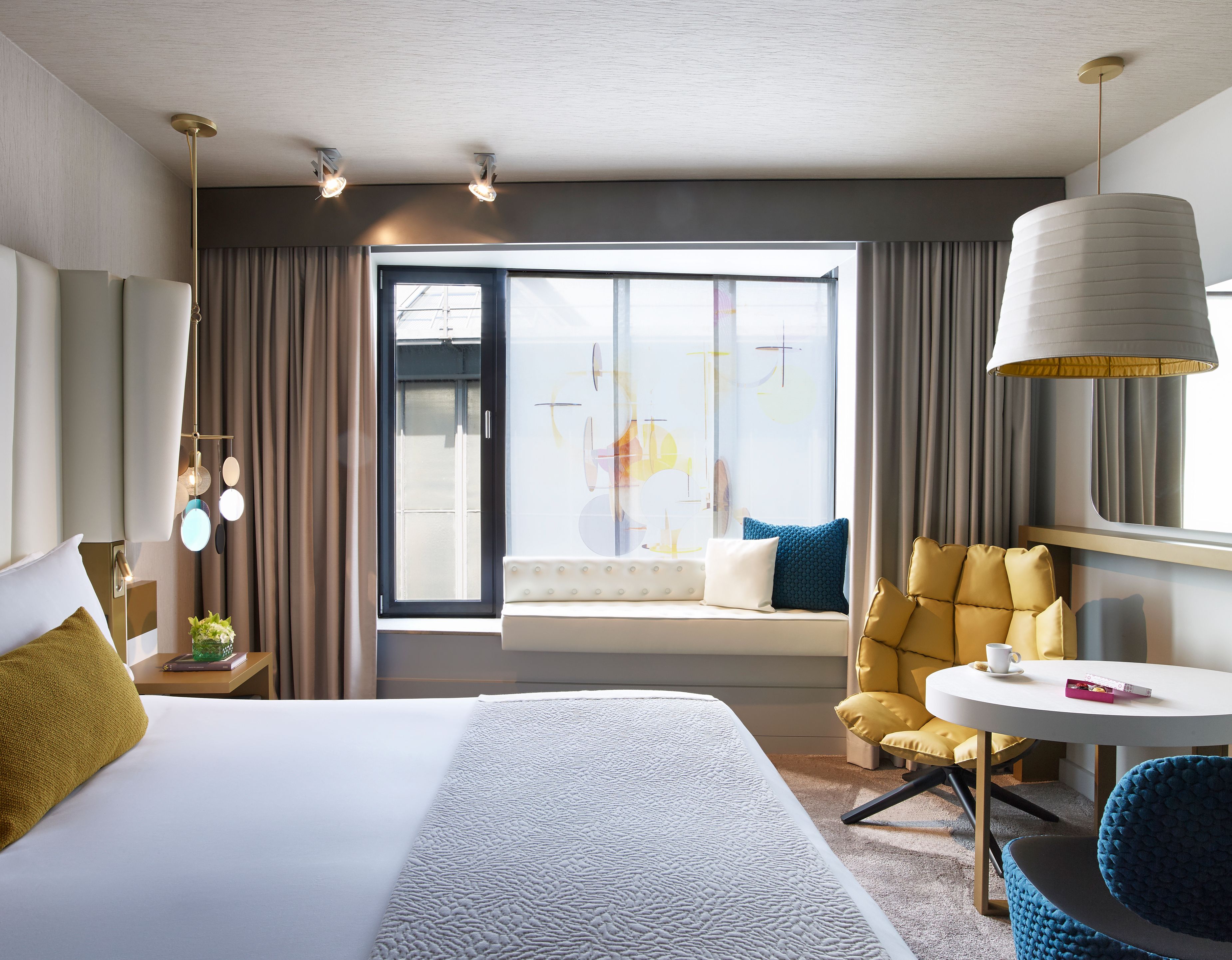a room with a bed and a table and chairs