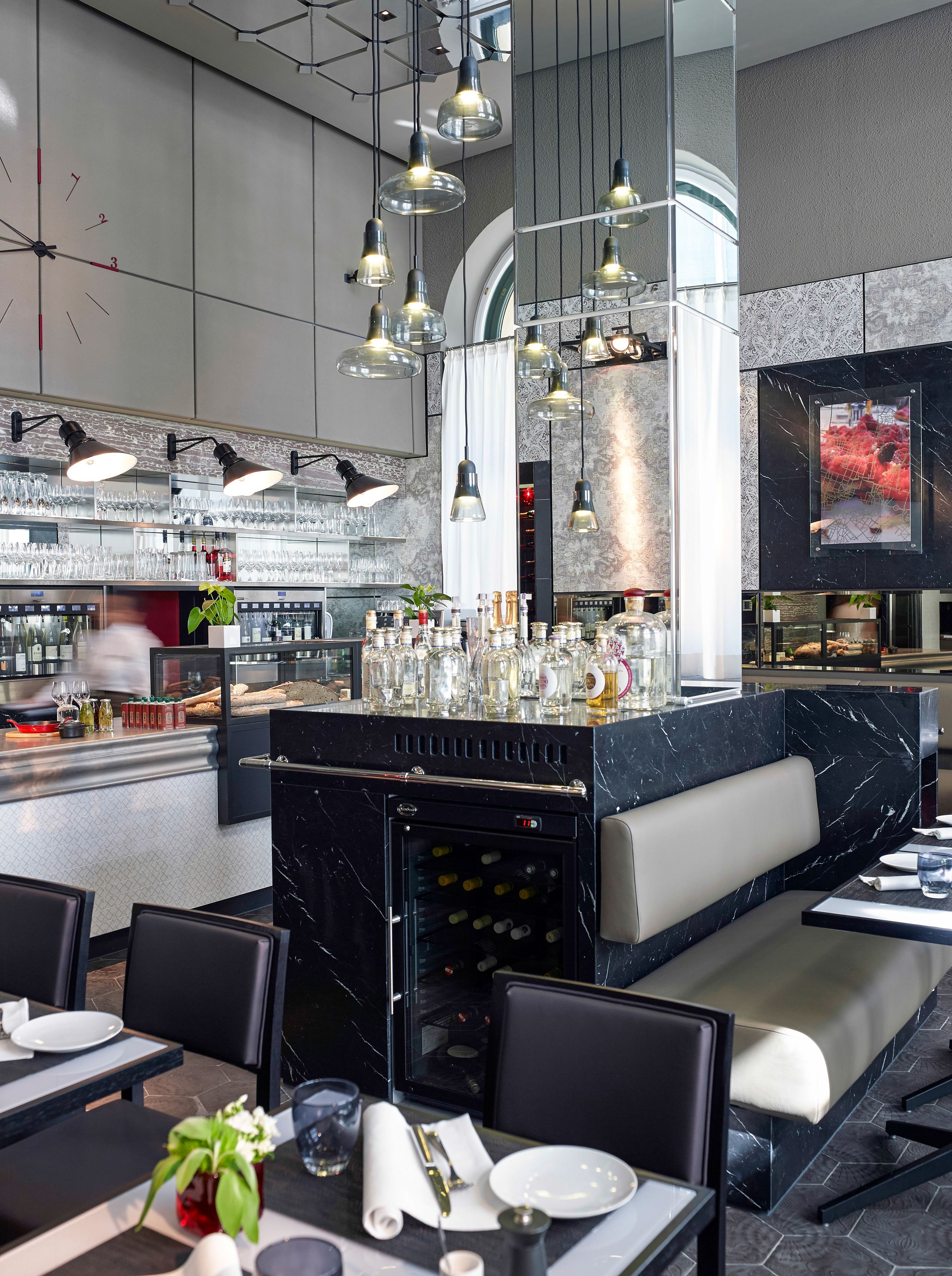 a restaurant with a bar and chairs