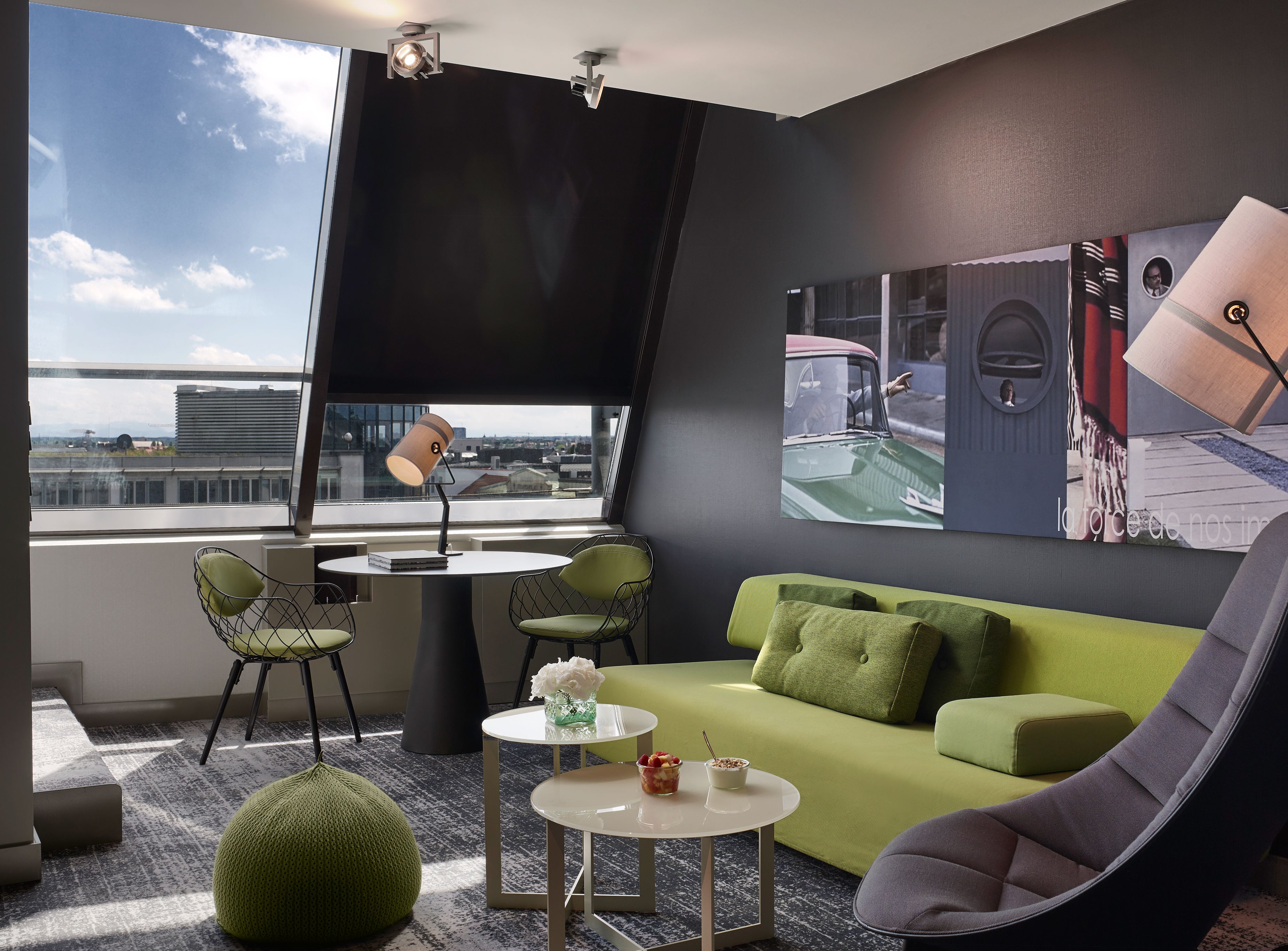 a room with a couch and chairs