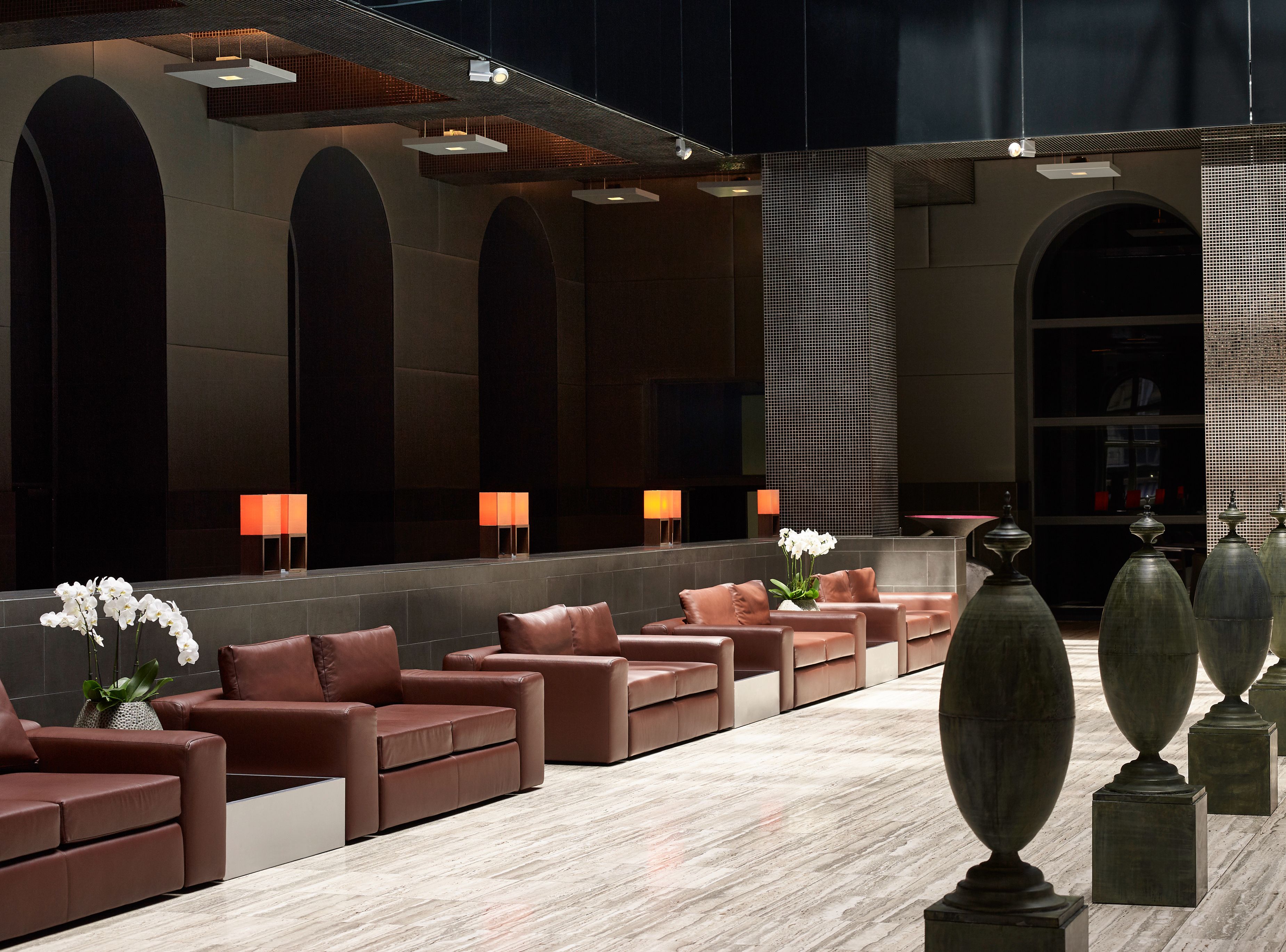 a room with brown chairs and vases