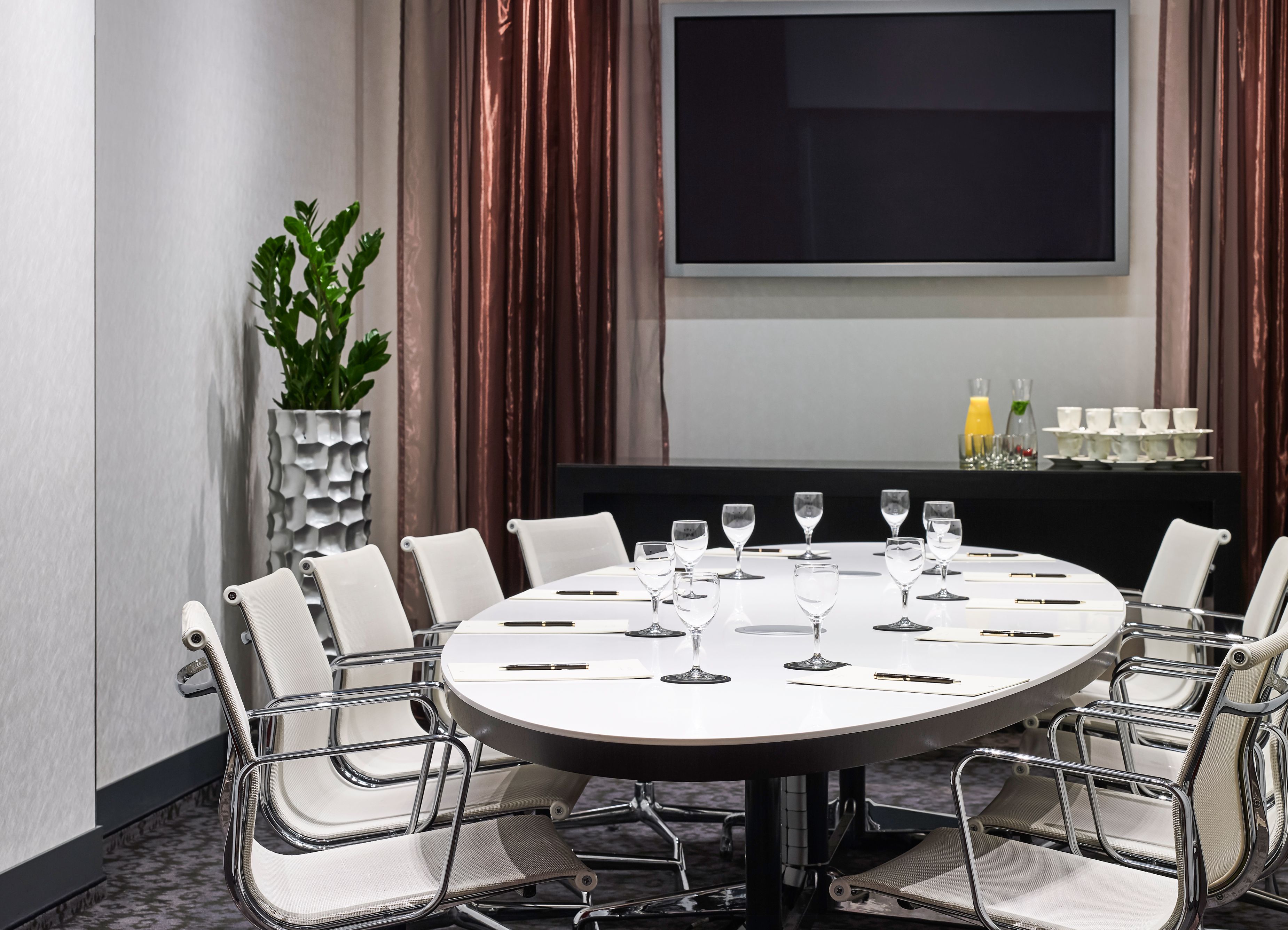 a table with wine glasses and chairs in a room