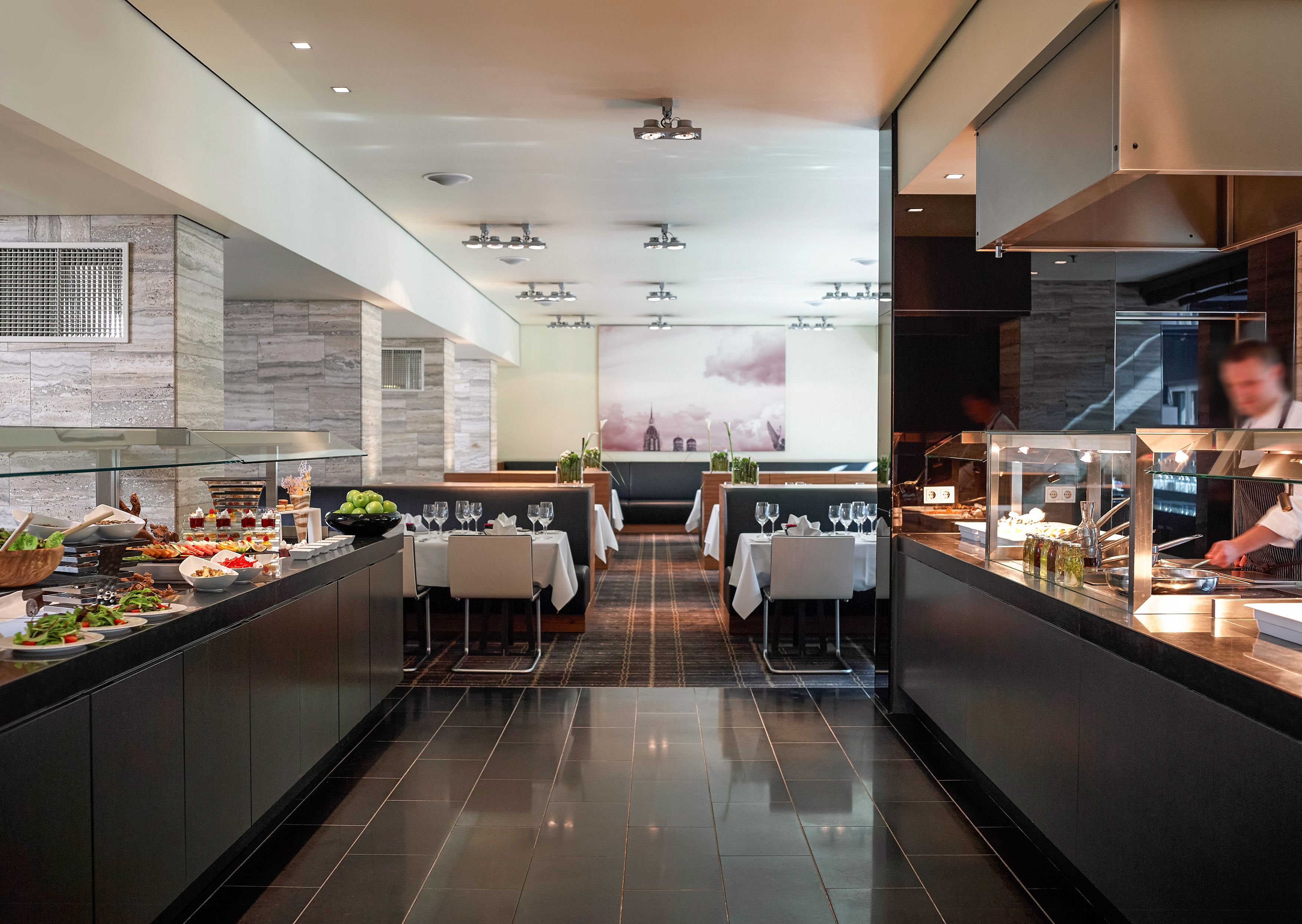 a restaurant with black counter tops and tables