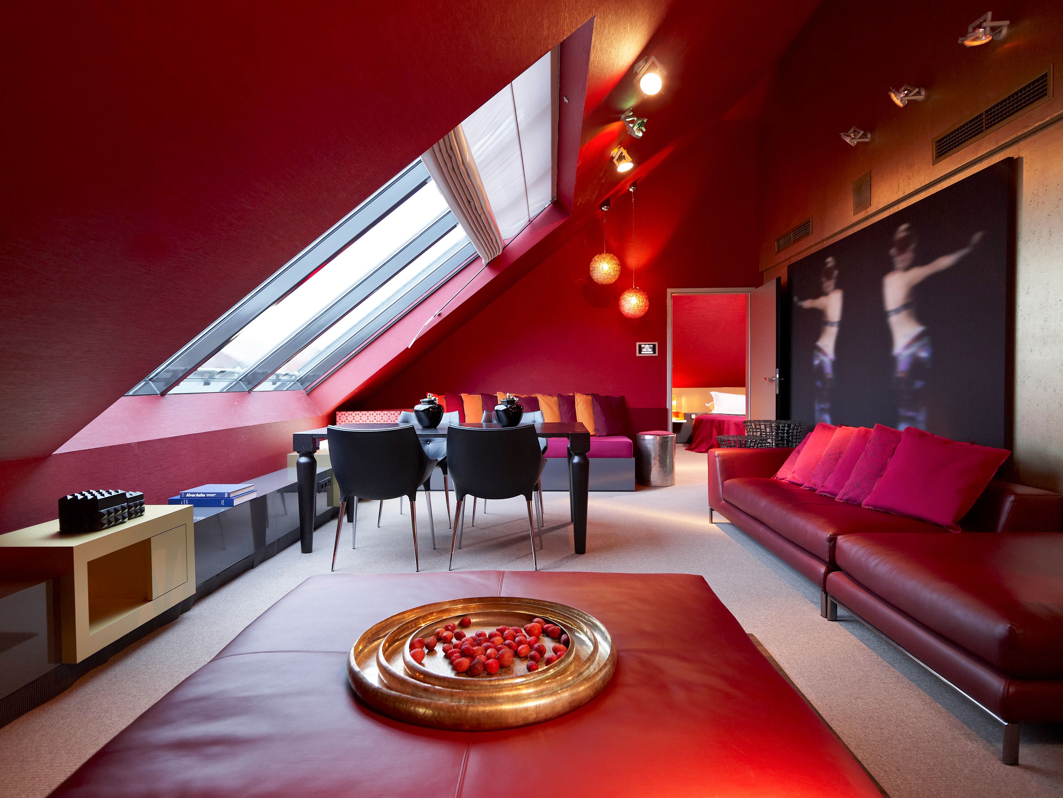 a room with red walls and a table and chairs