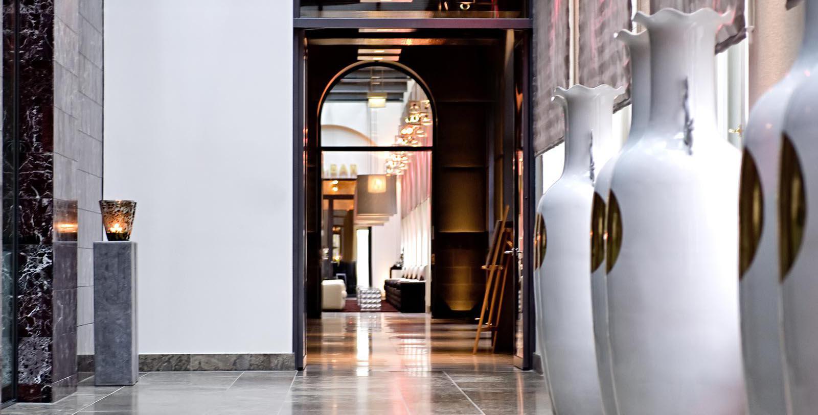 a hallway with large vases