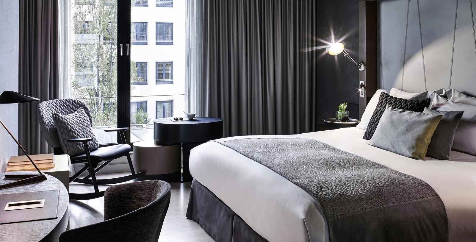 a bedroom with a bed and a table and chairs