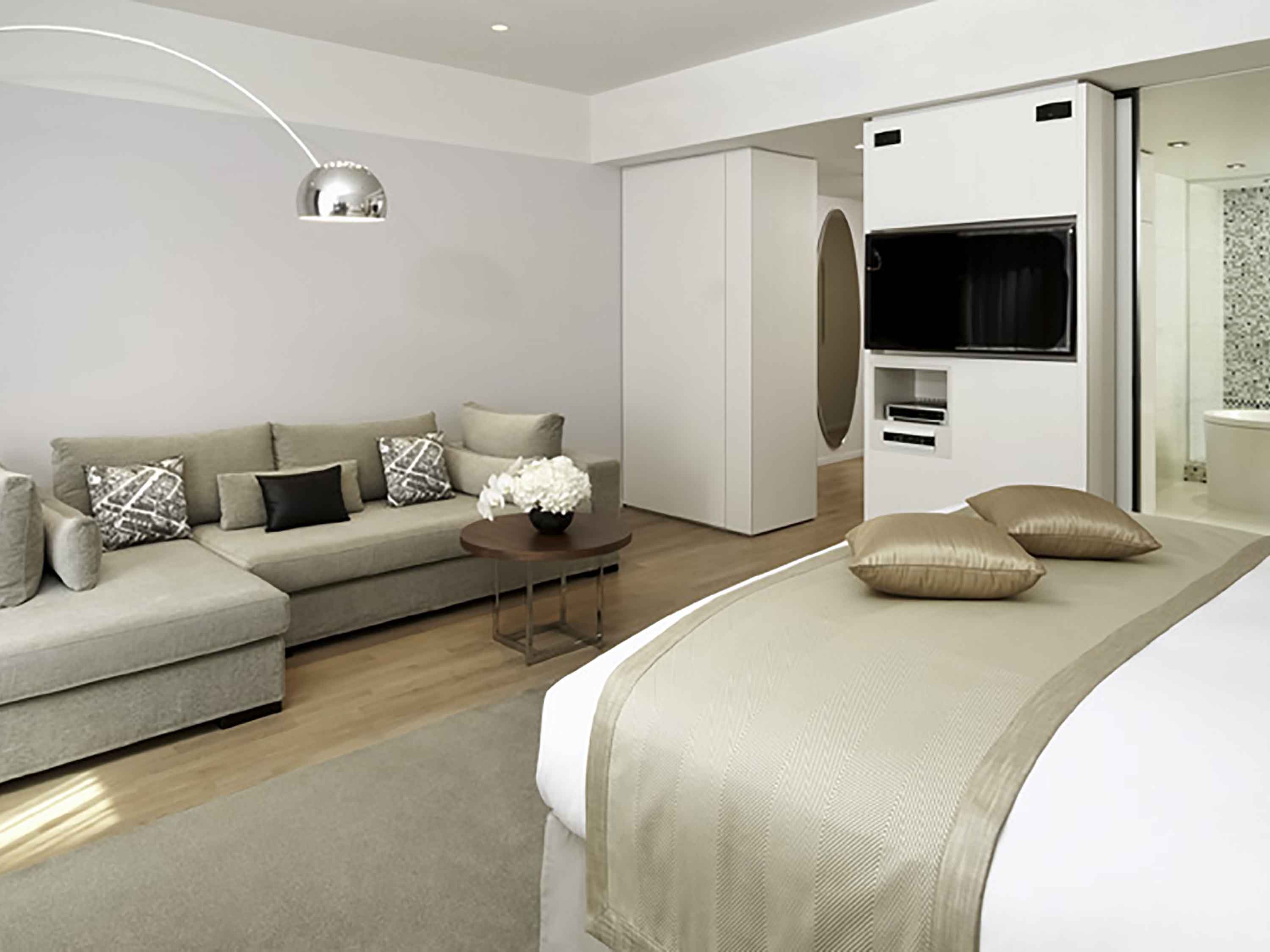 a bedroom with a large bed and a couch