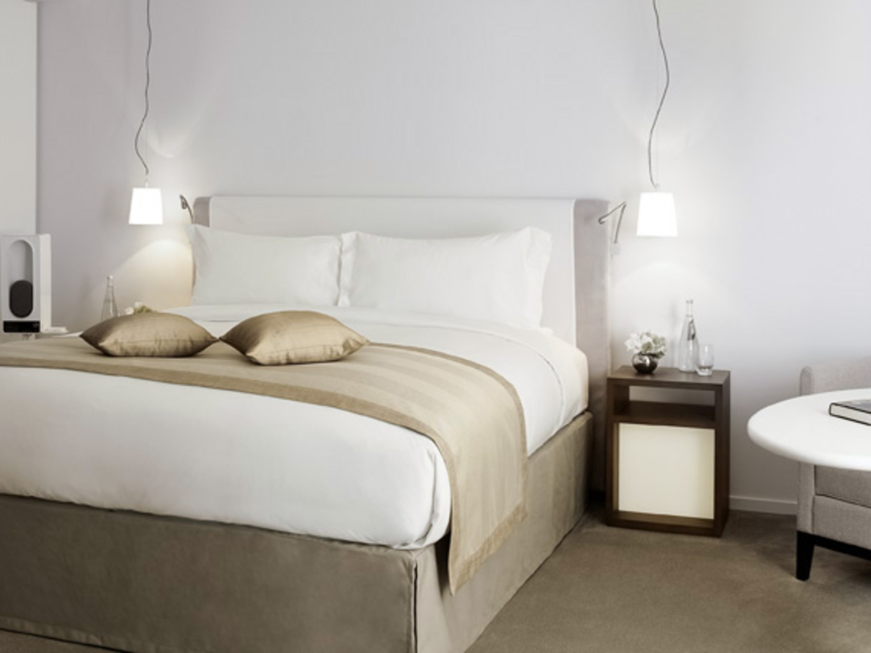 a bed with a white bedding and a brown bedding