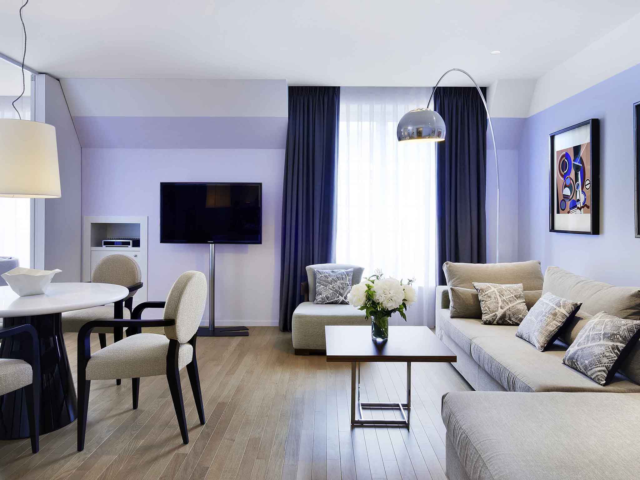 a living room with a table and couches