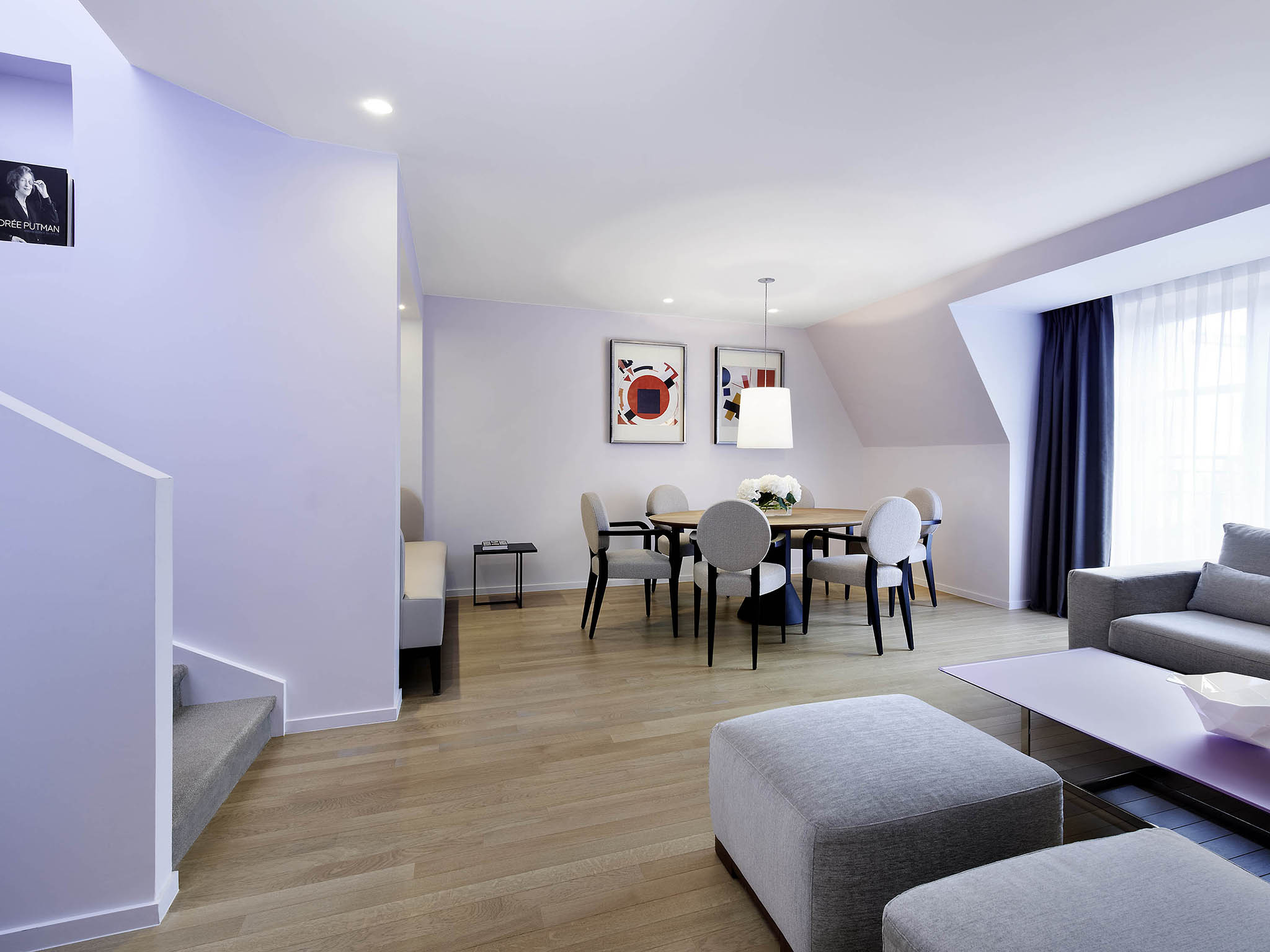 a living room with a table and chairs