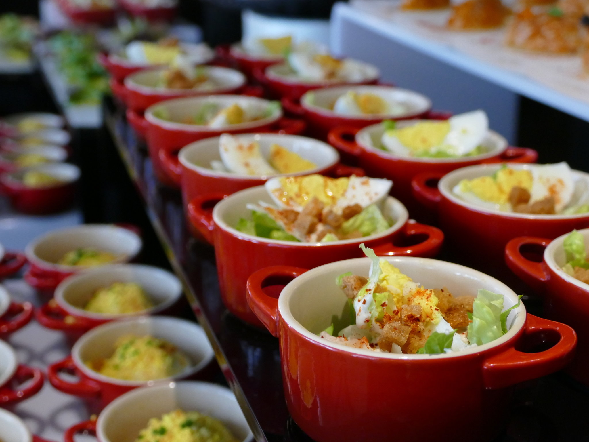 a row of red bowls of food