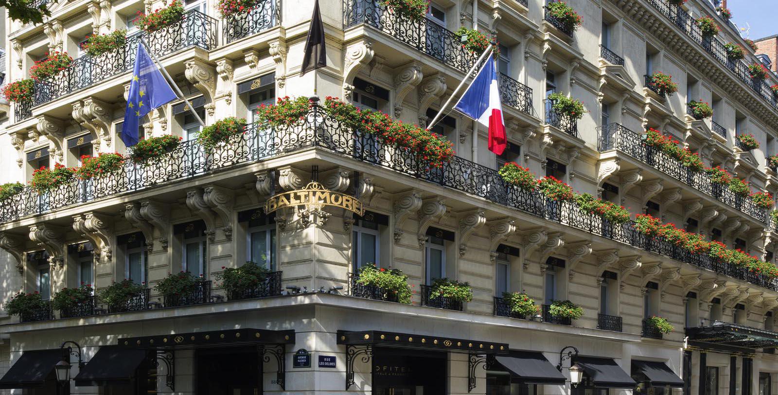 a building with a flag on the balcony