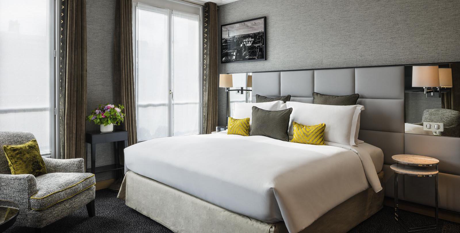a bed with pillows and a lamp in a room