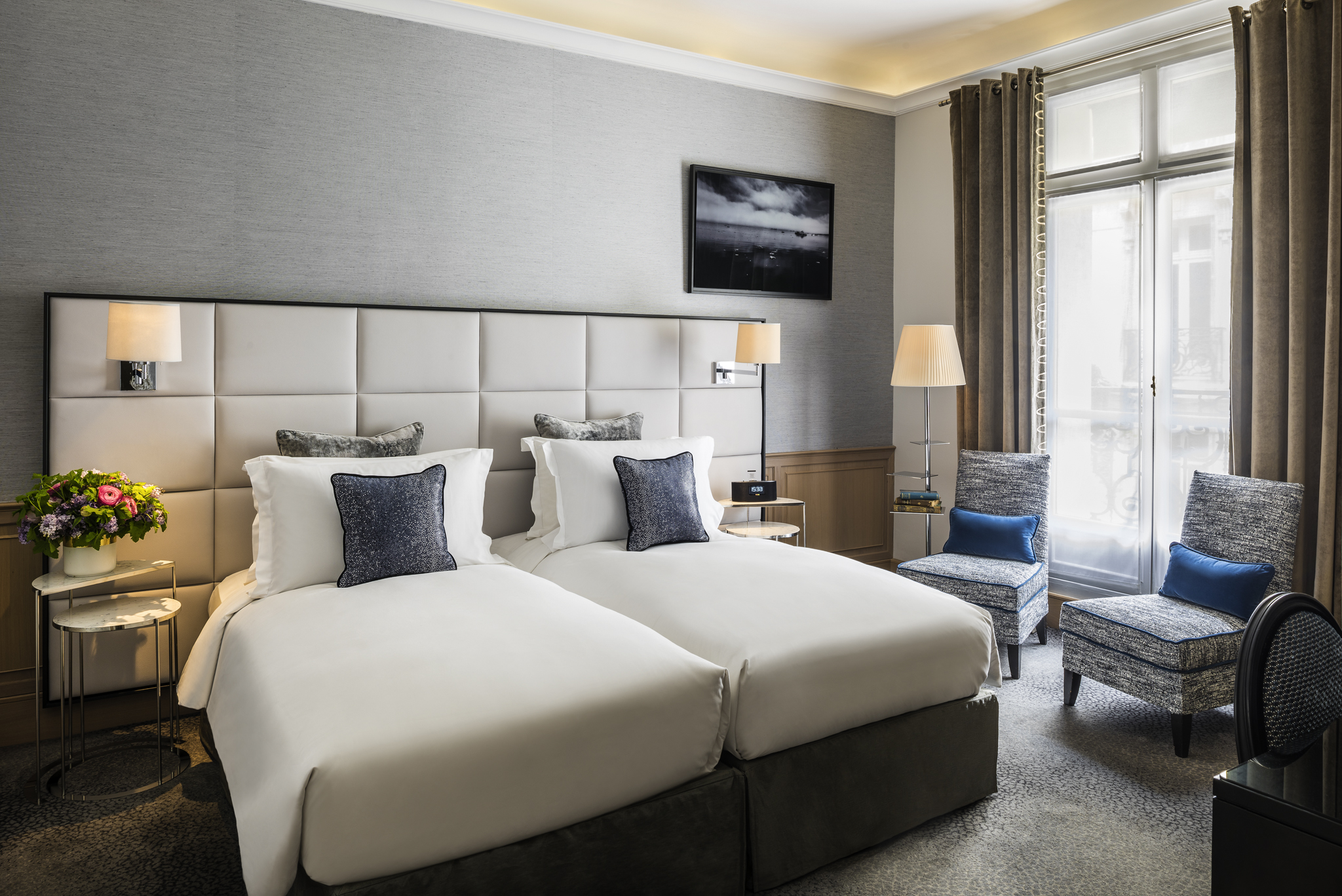 a room with two beds and a chair