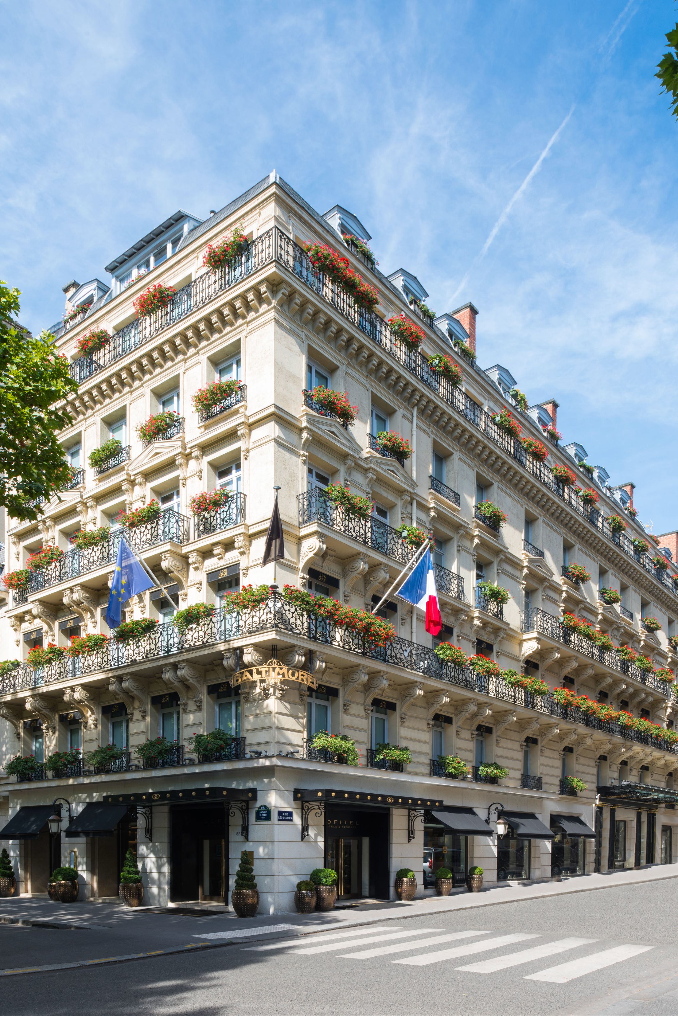 a building with flags on the balcony
