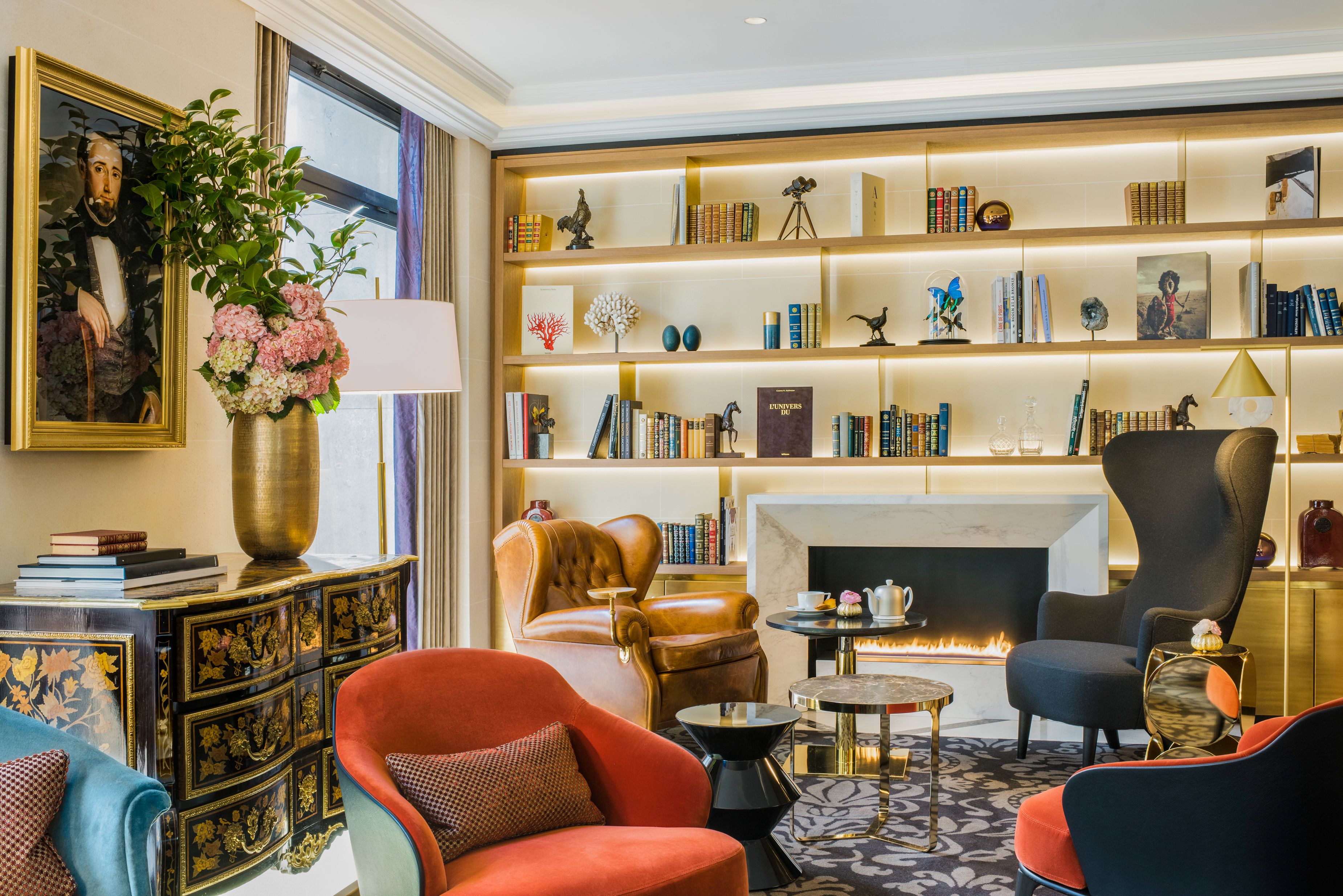 a room with a fireplace and bookshelves