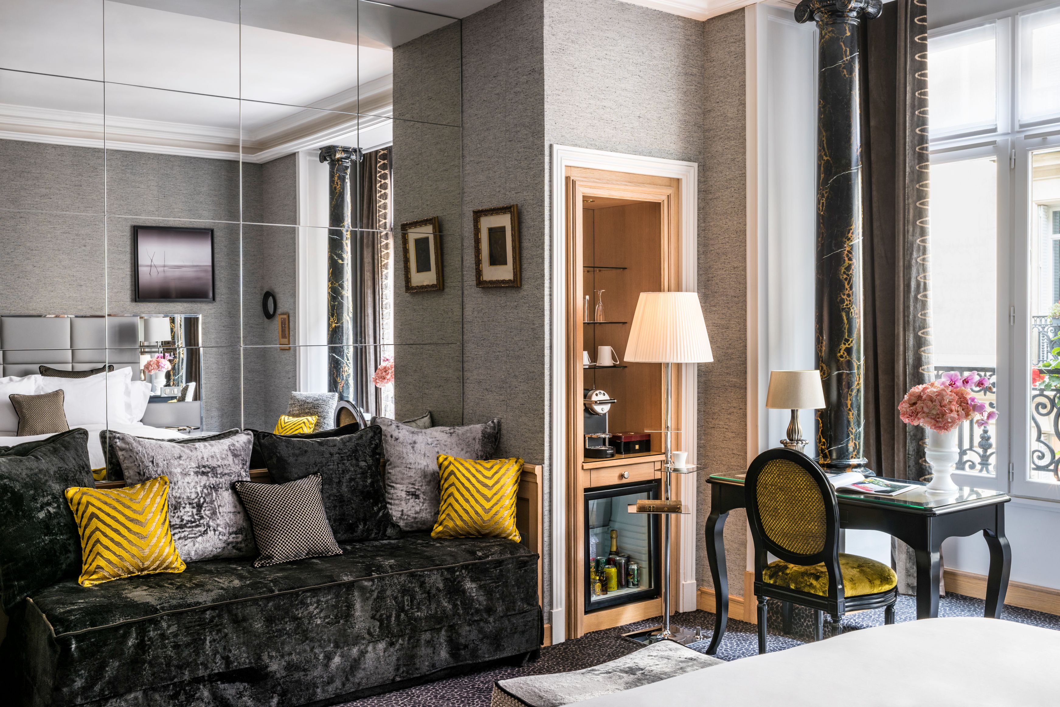 a room with a couch and a mirror