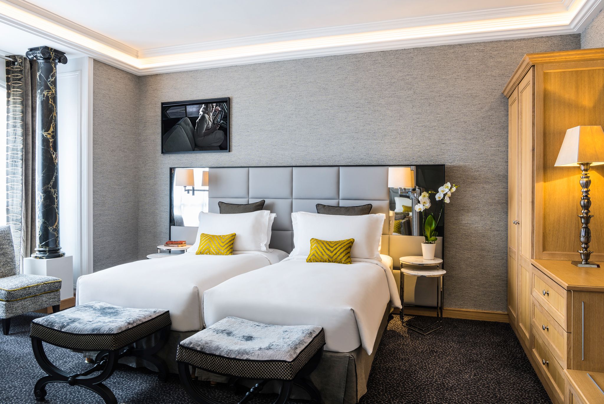 a room with two beds and a lamp