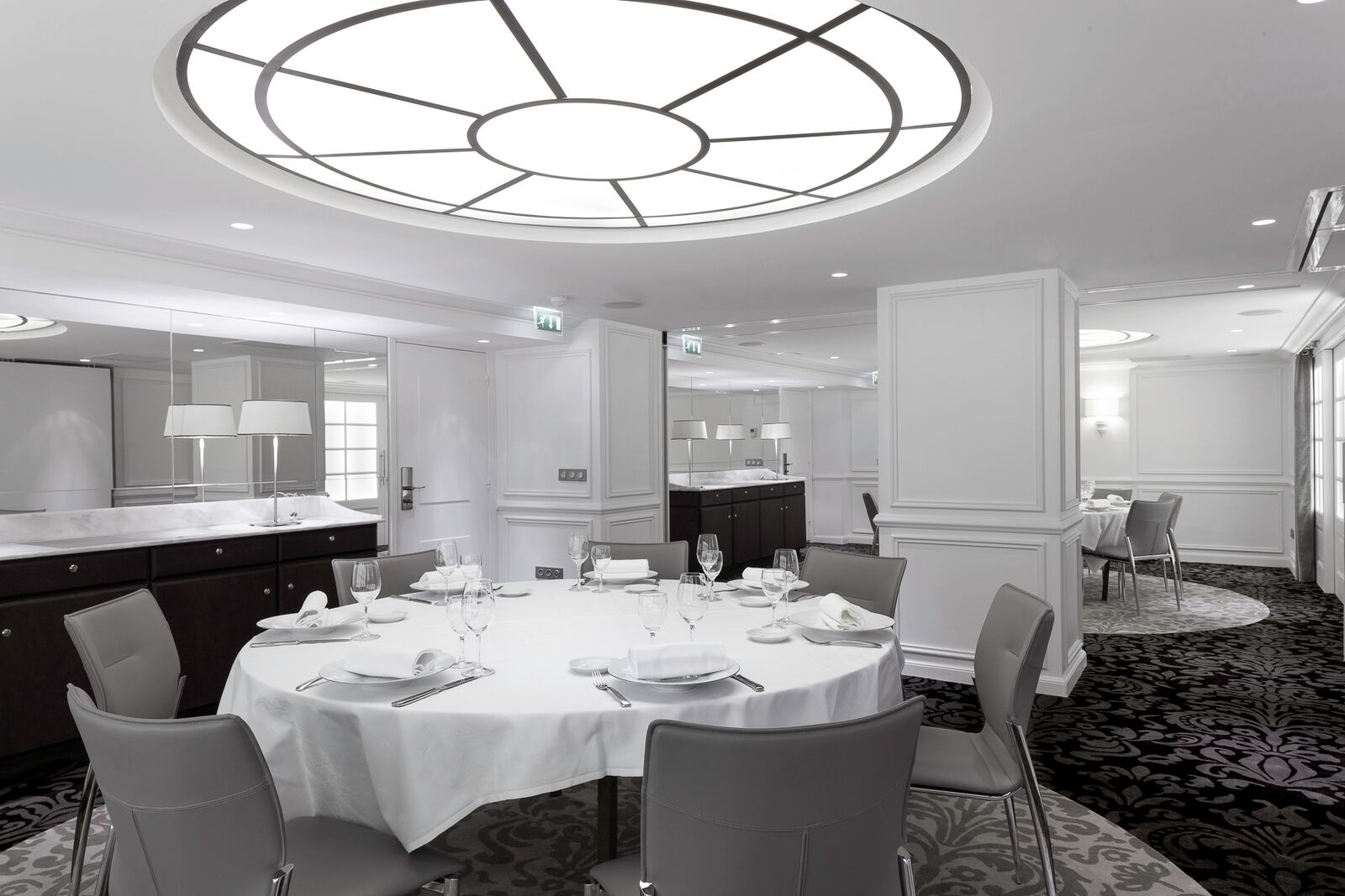 a room with a round table and chairs