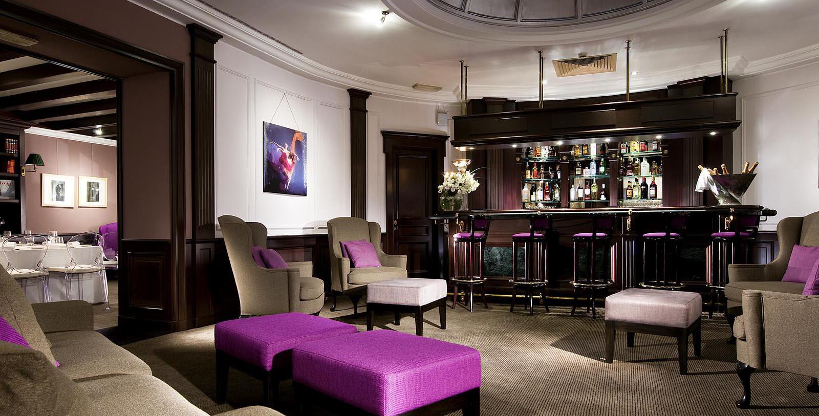 a room with a bar and stools