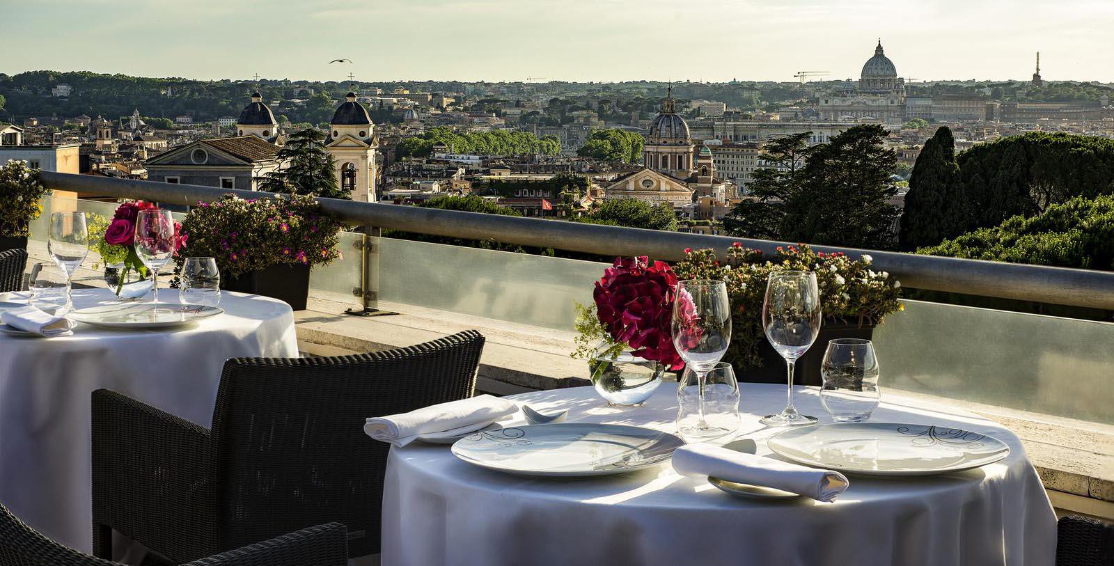 a table set up for a dinner with a view of a city