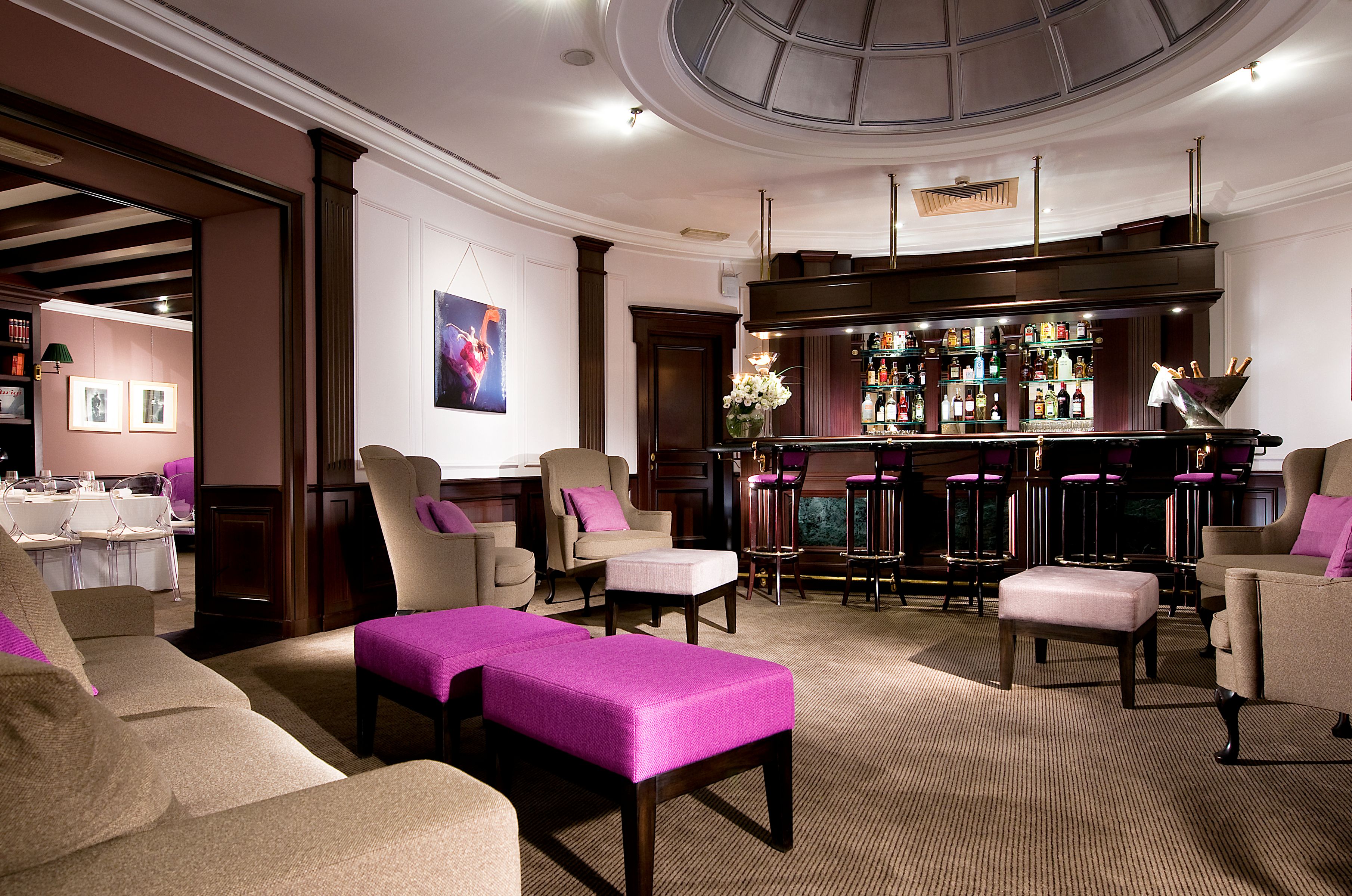 a room with a bar and stools