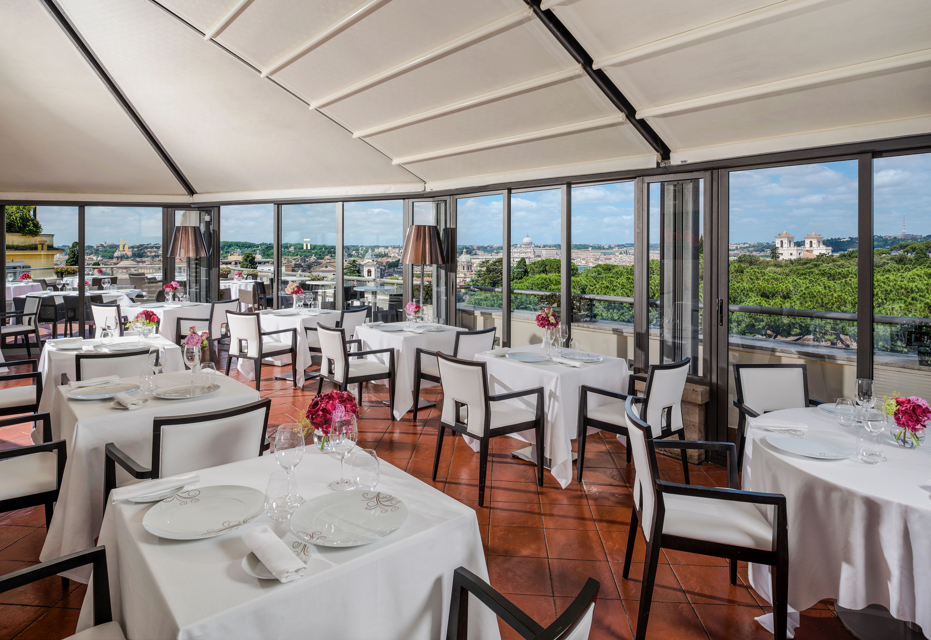 a room with tables and chairs and a view of the city