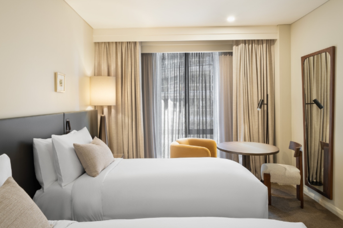 a hotel room with two beds and a table