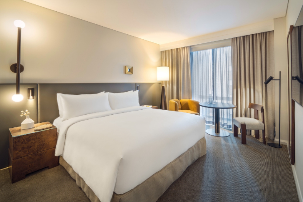 a hotel room with a bed and chairs