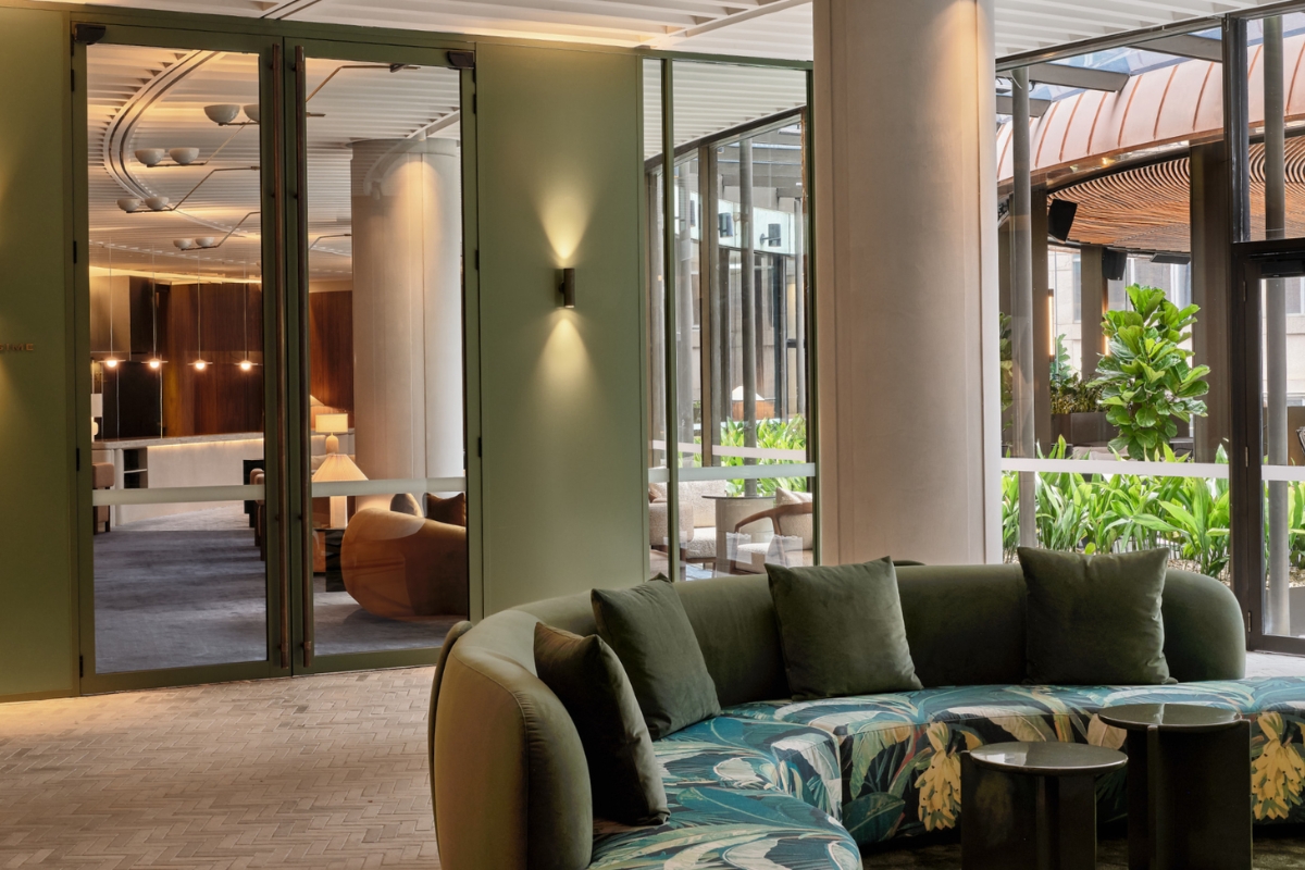 a round couch in a room with glass doors