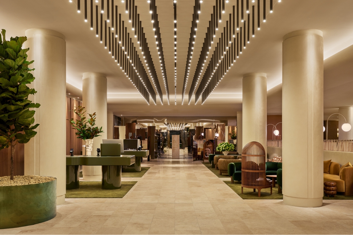a lobby with a large white ceiling and a green table and chairs