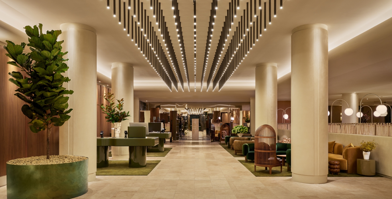 a lobby with a large white ceiling and a large green table and chairs