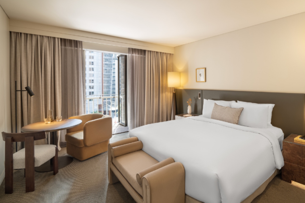 a hotel room with a bed and chairs