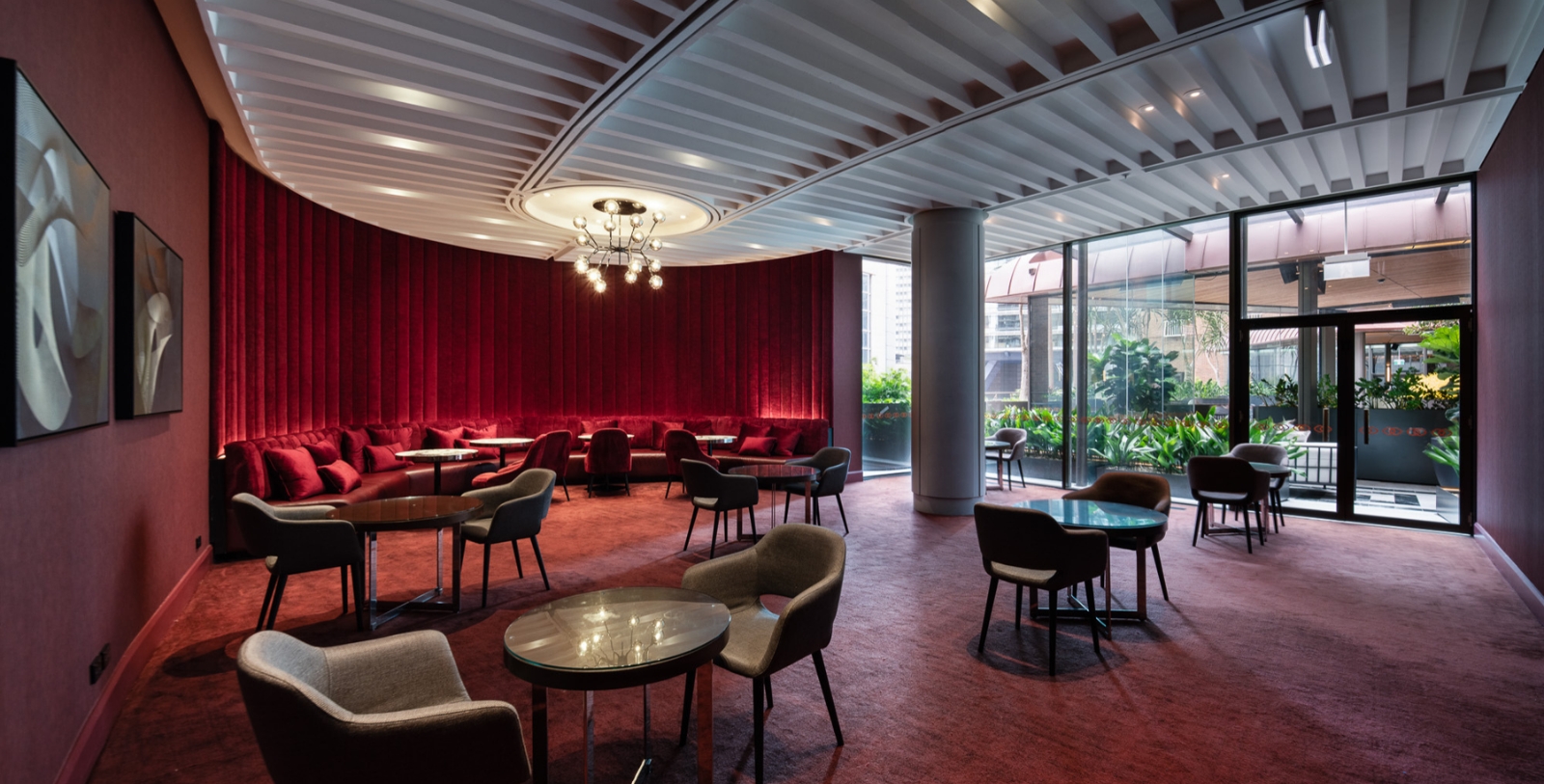 a room with red curtains and tables and chairs