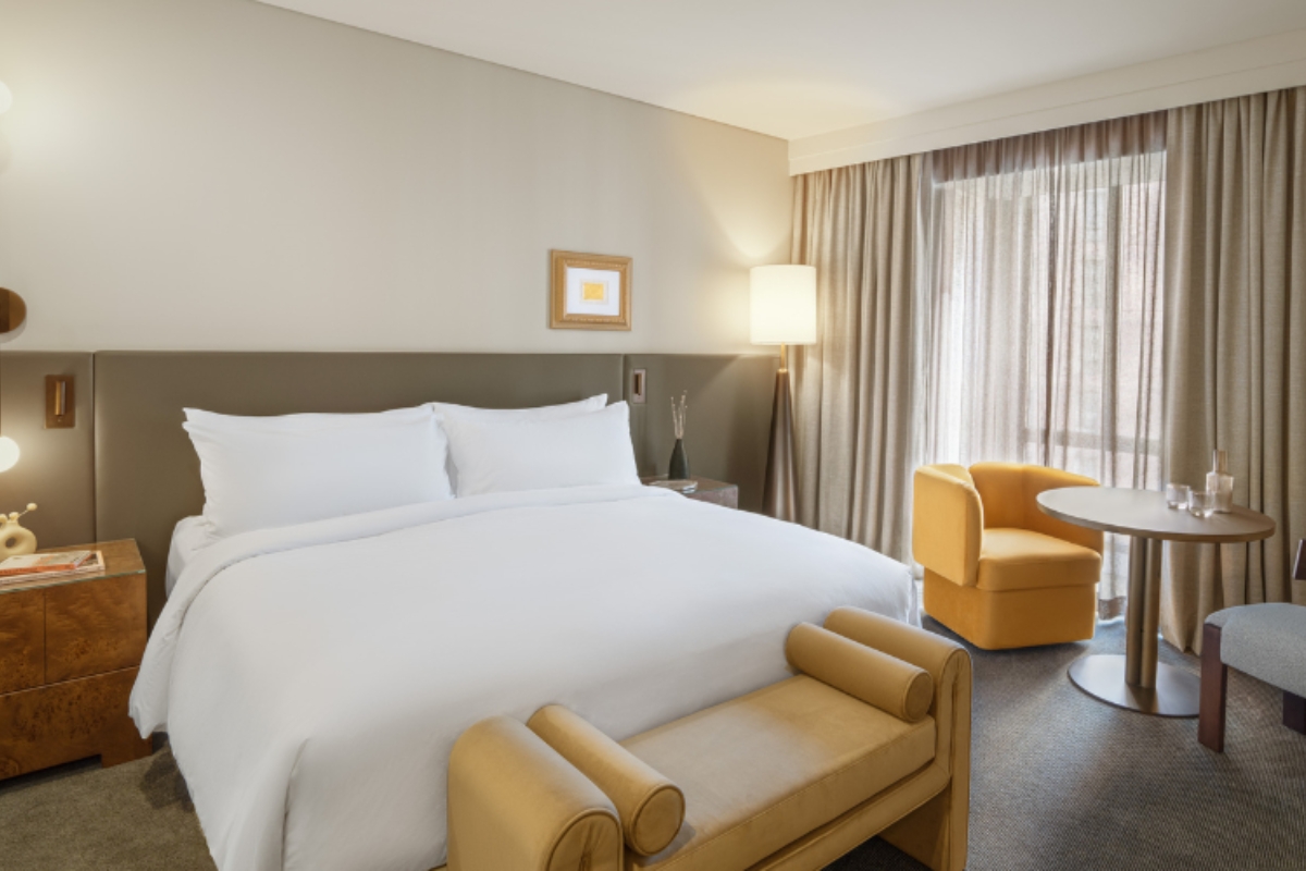 a hotel room with a bed and chairs