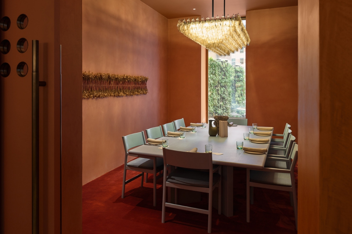 a table with plates and chairs in a room with a chandelier