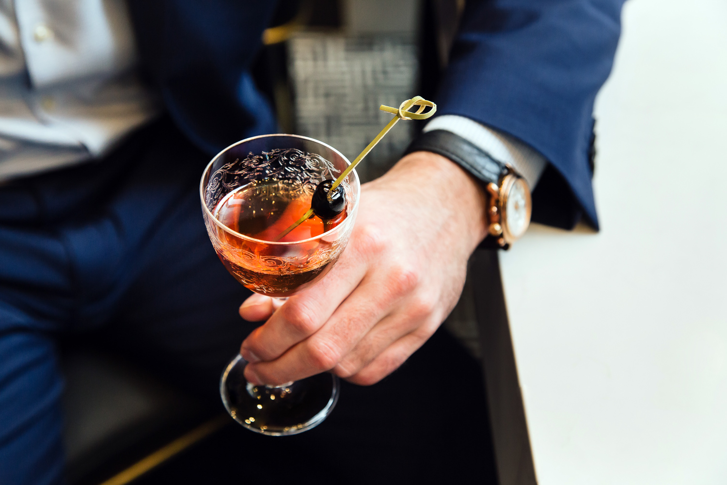 a hand holding a drink