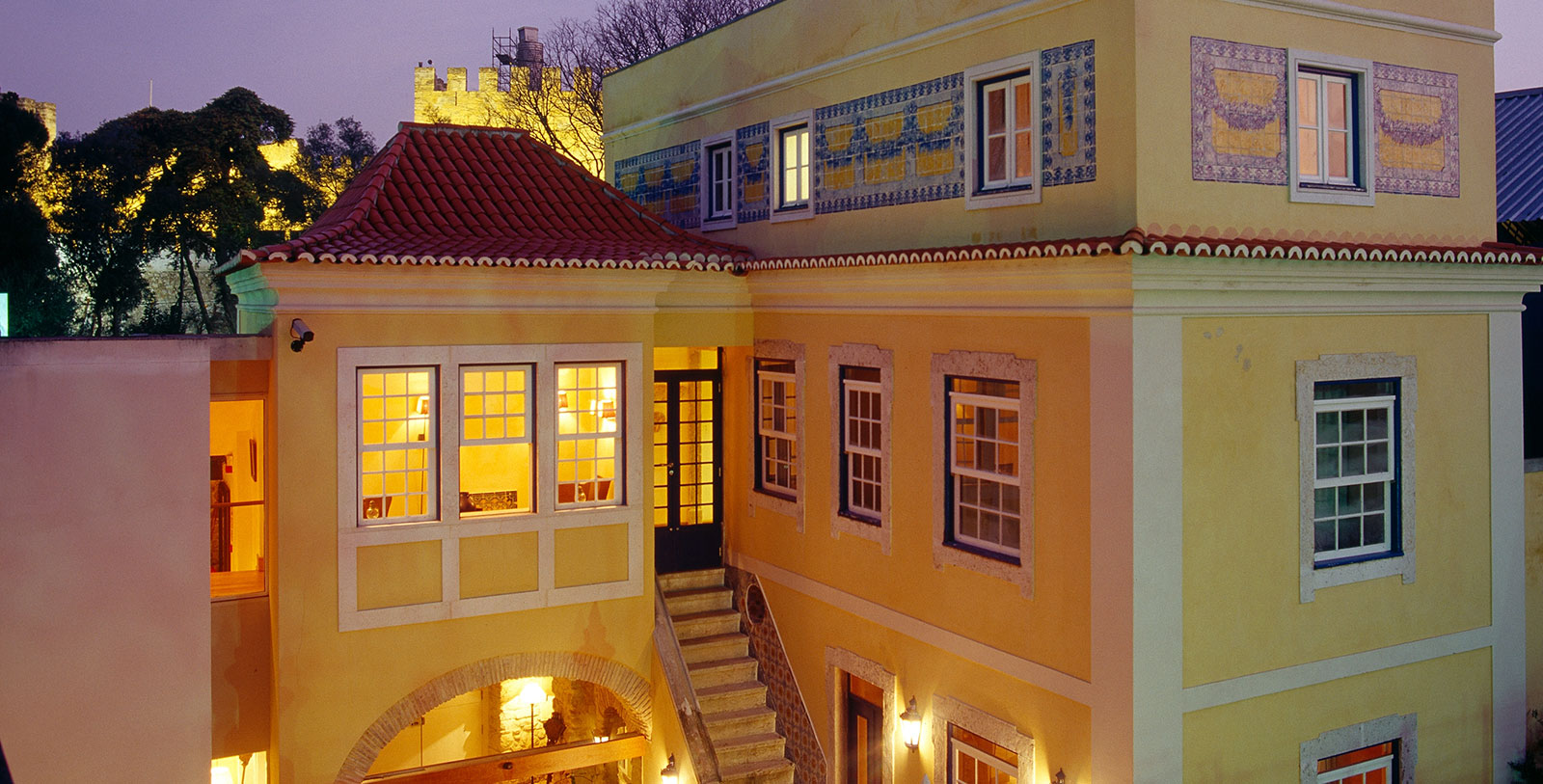a building with a staircase and a red roof