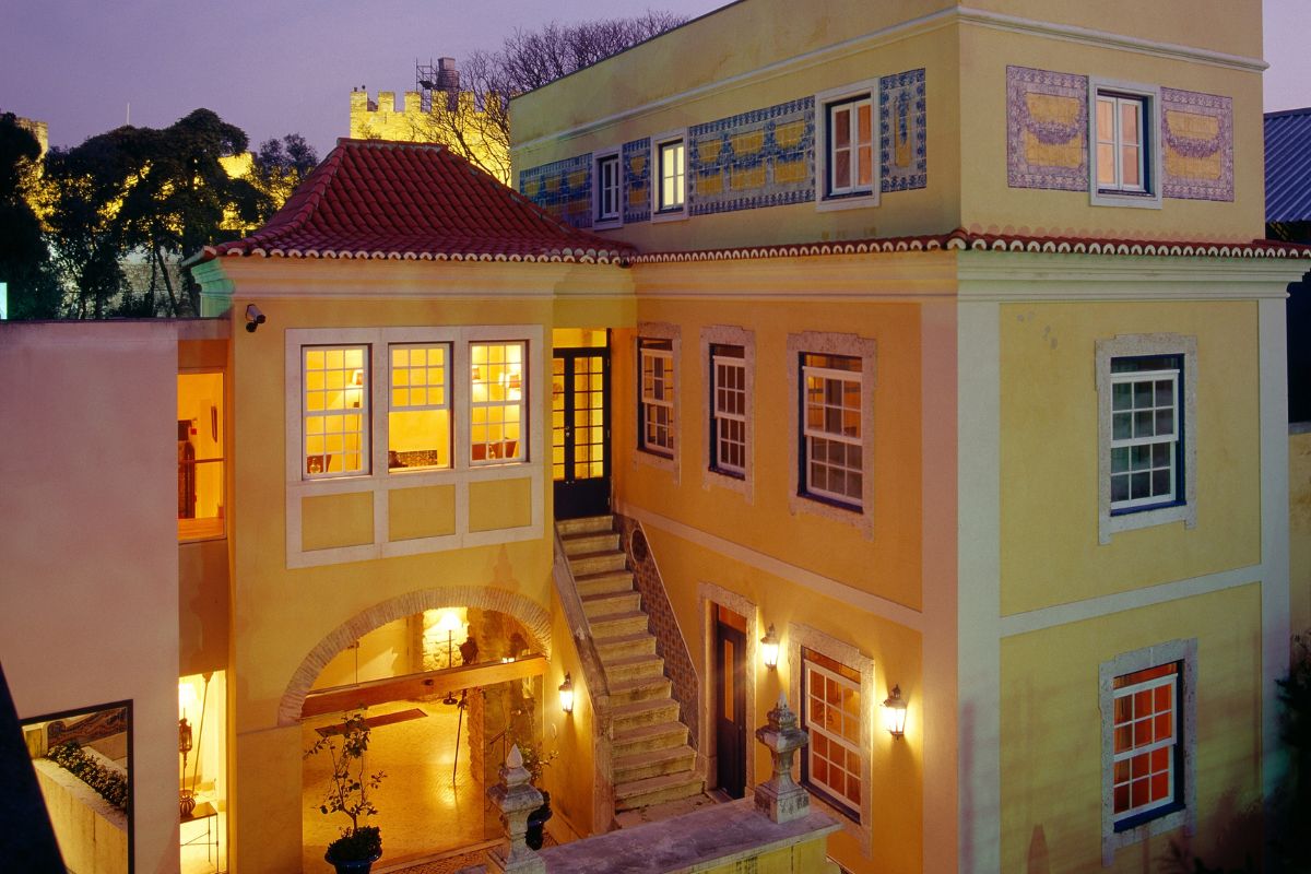 a building with a staircase and a red roof